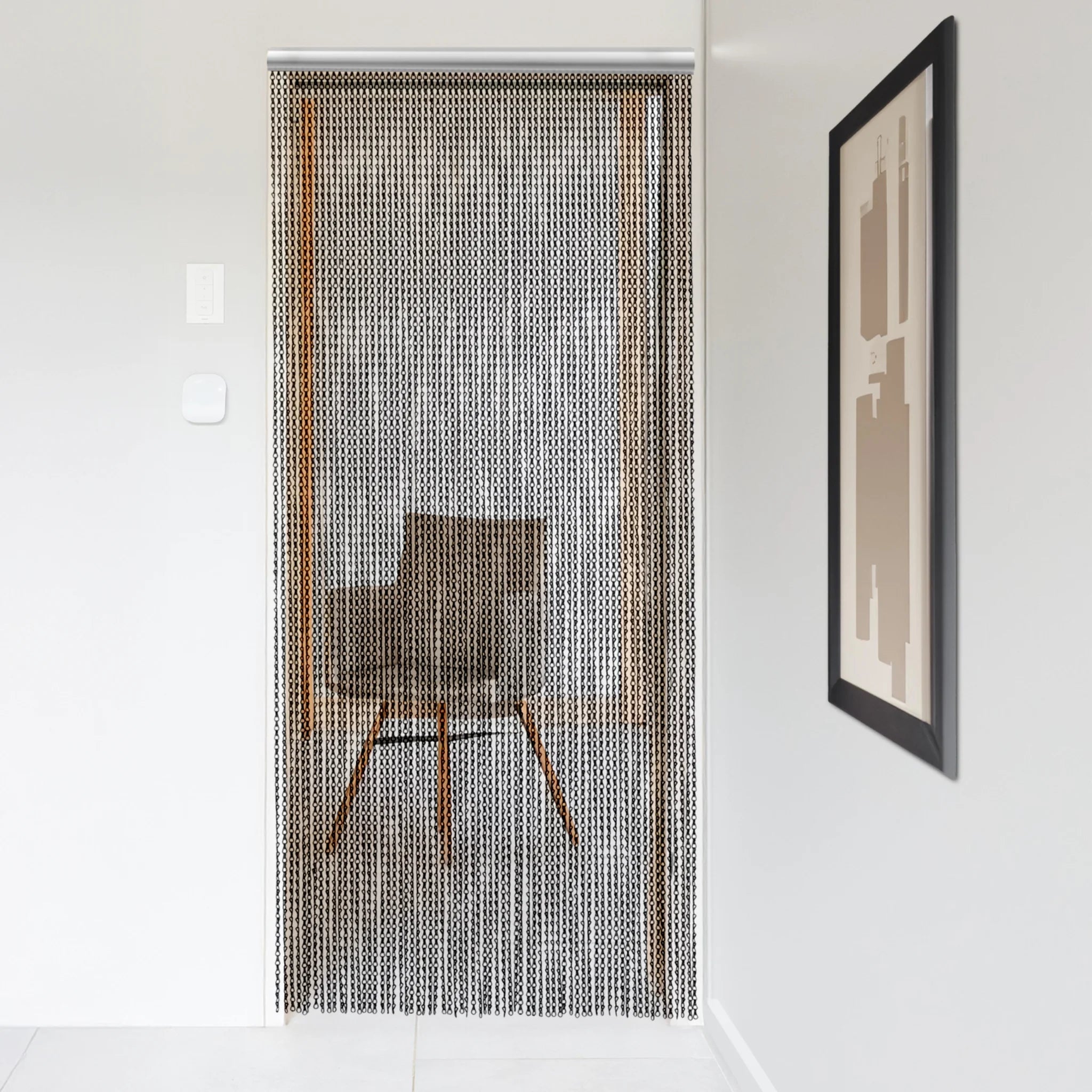 Black metal chain curtain hanging in a modern doorway