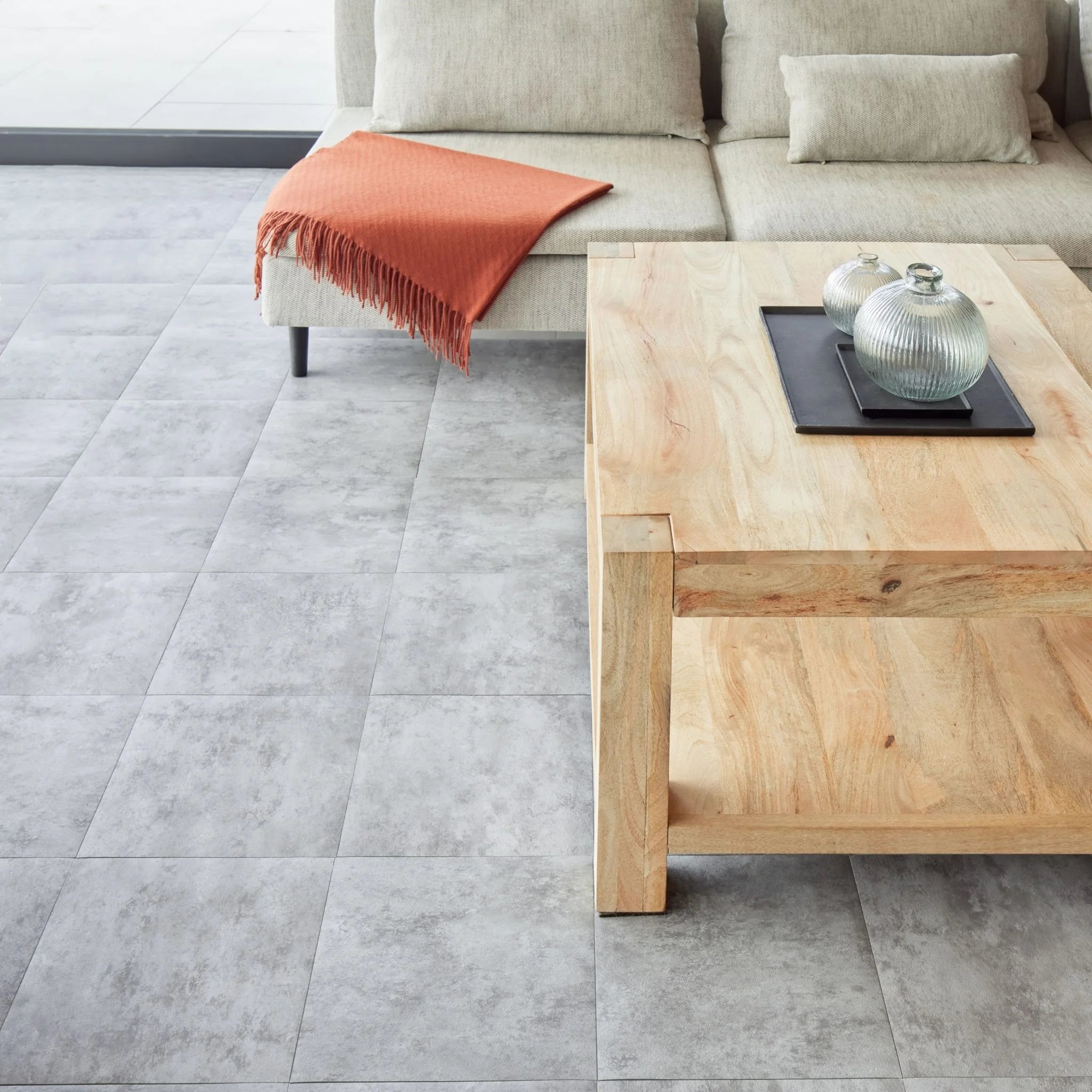 spacious living room with rustic furniture and grey tile-effect concrete flooring