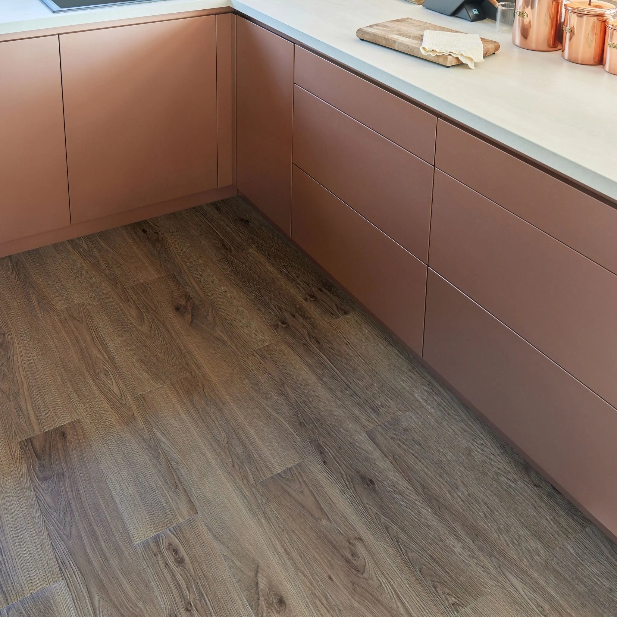 modern kitchen corner with brown cabinets and dark brown wood-effect flooring