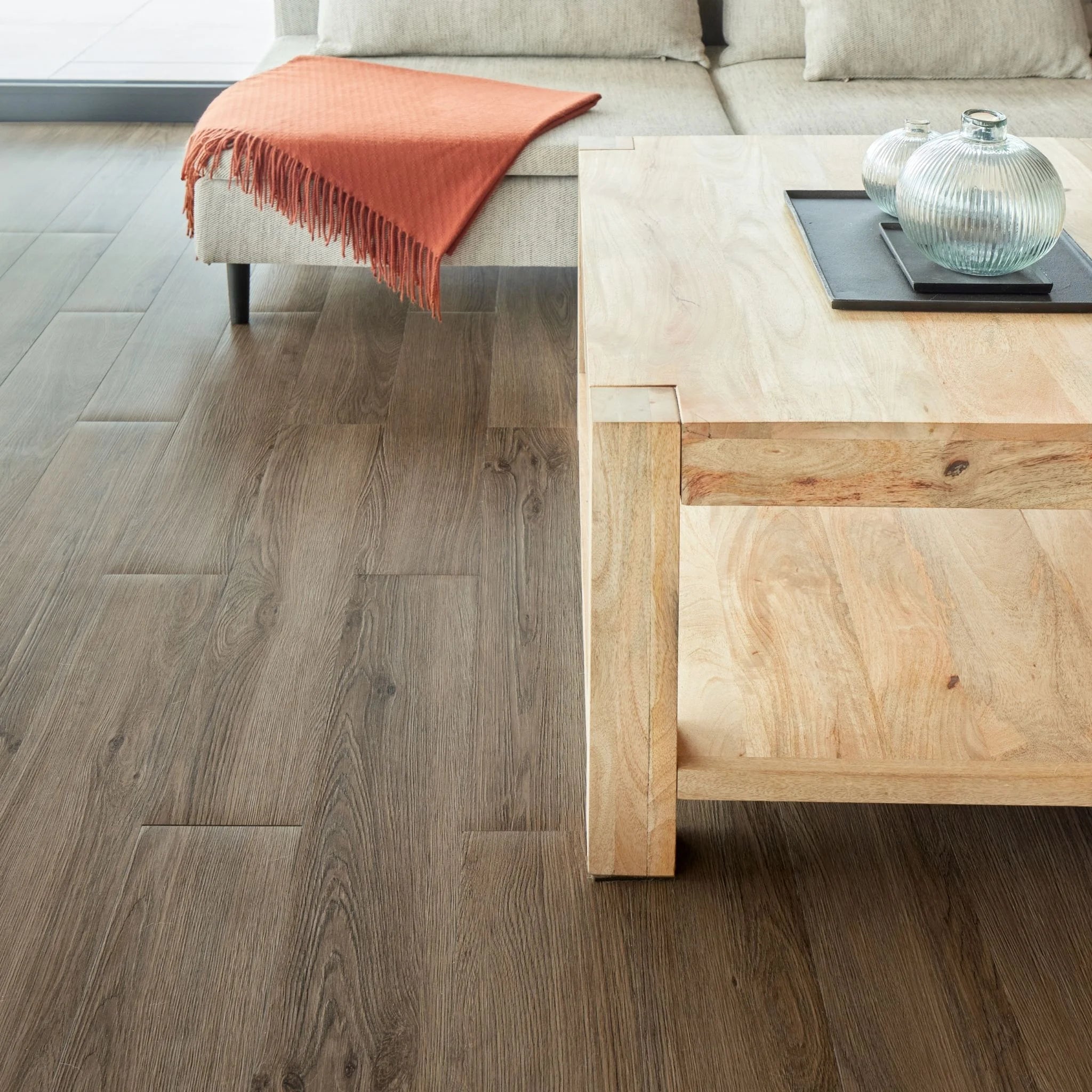 spacious living room with rustic furniture and dark brown wood-effect vinyl flooring