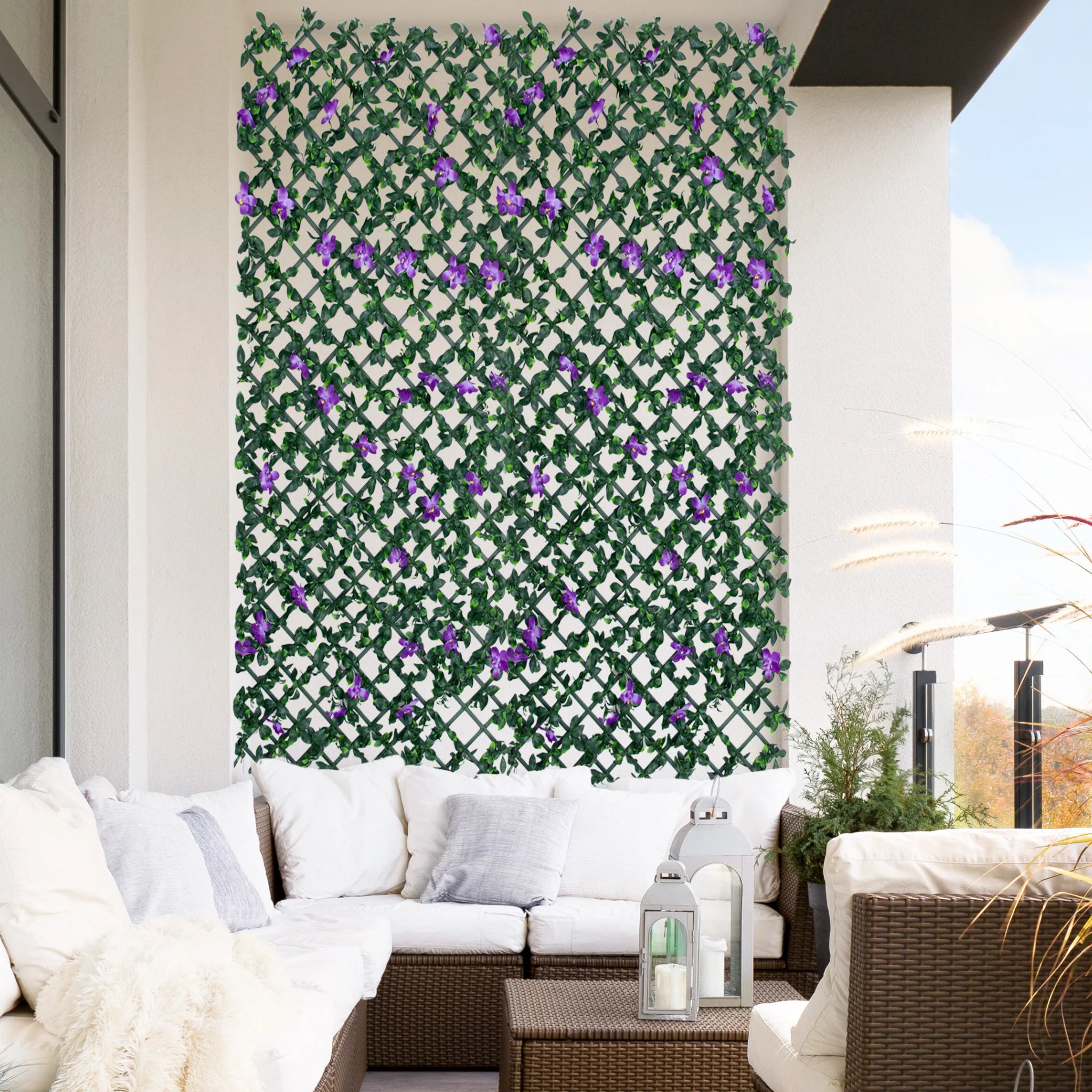 expanding trellis with artificial leaves purple flowers on balcony wall