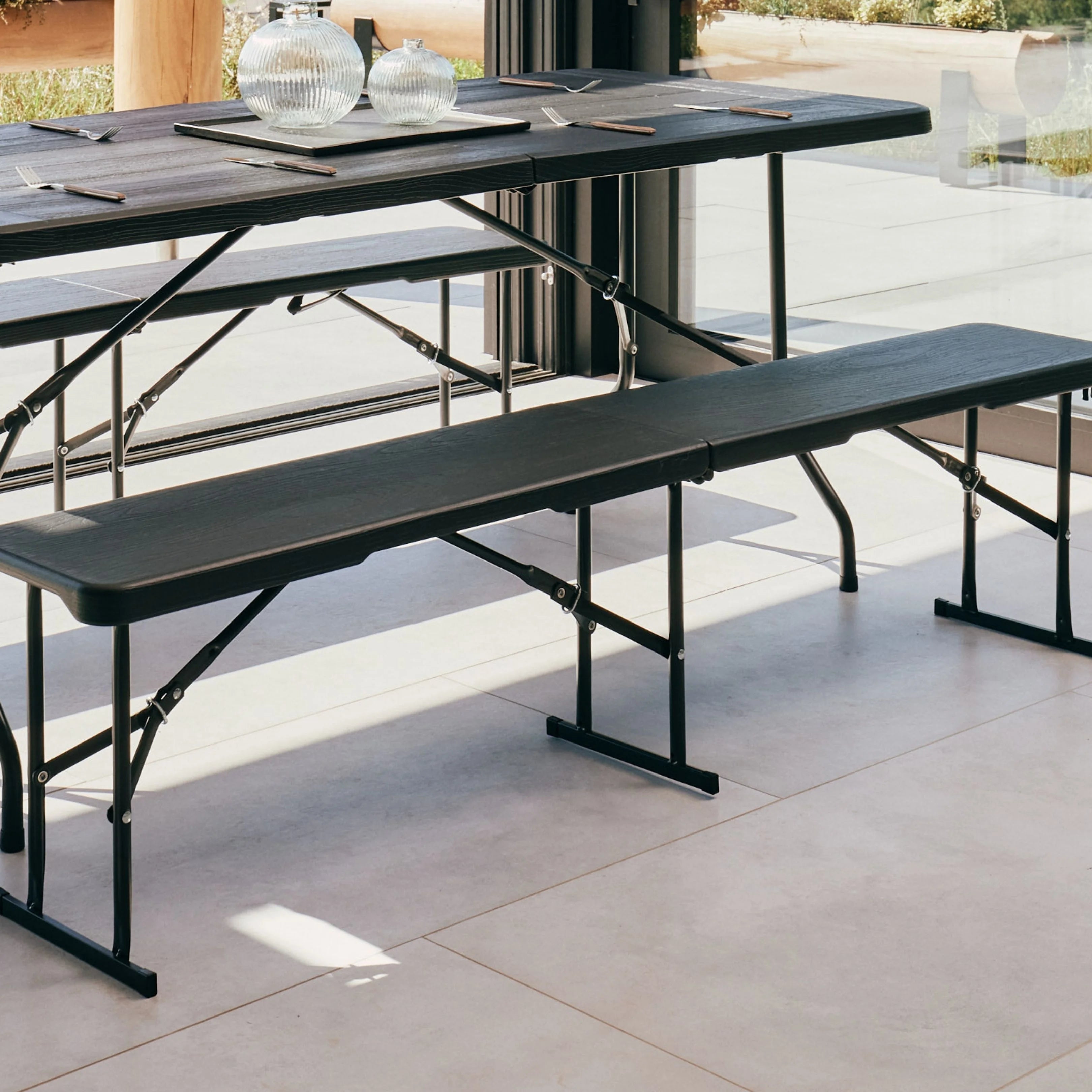 black folding bench on patio with a scenic view