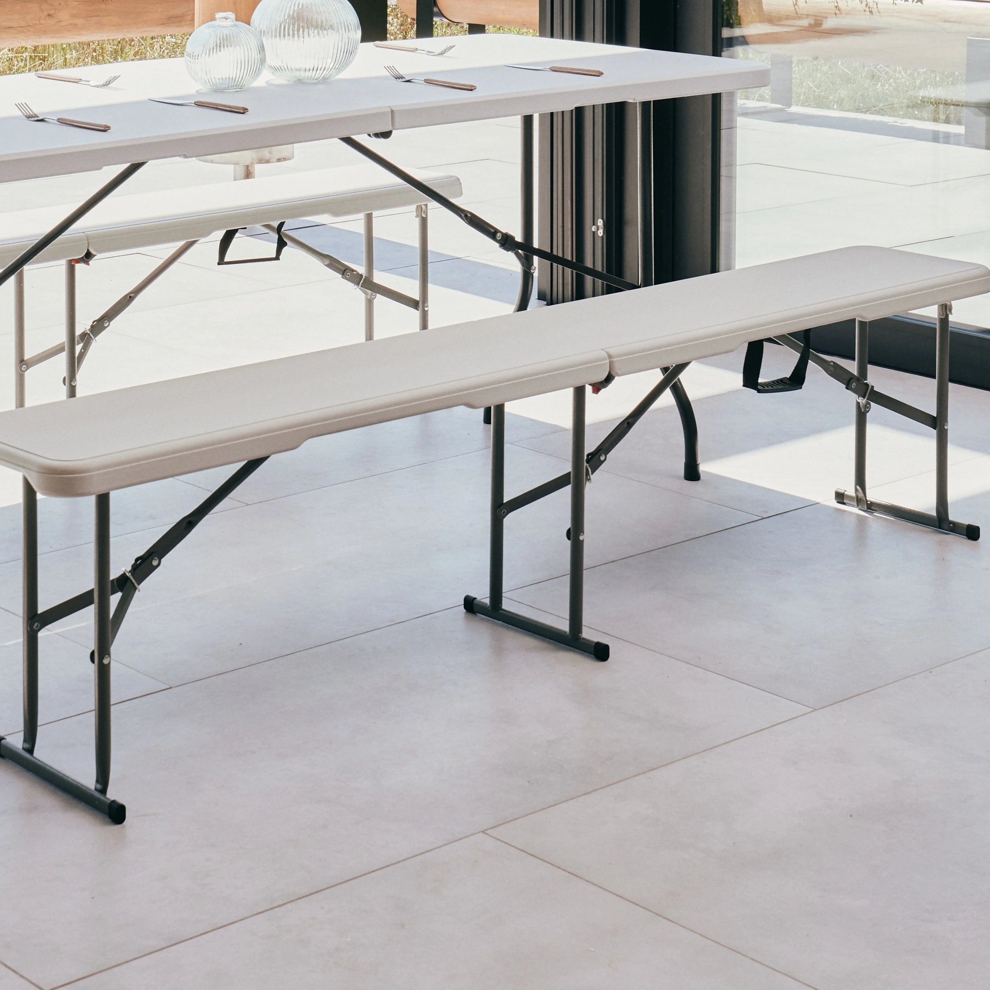 white folding bench on a patio