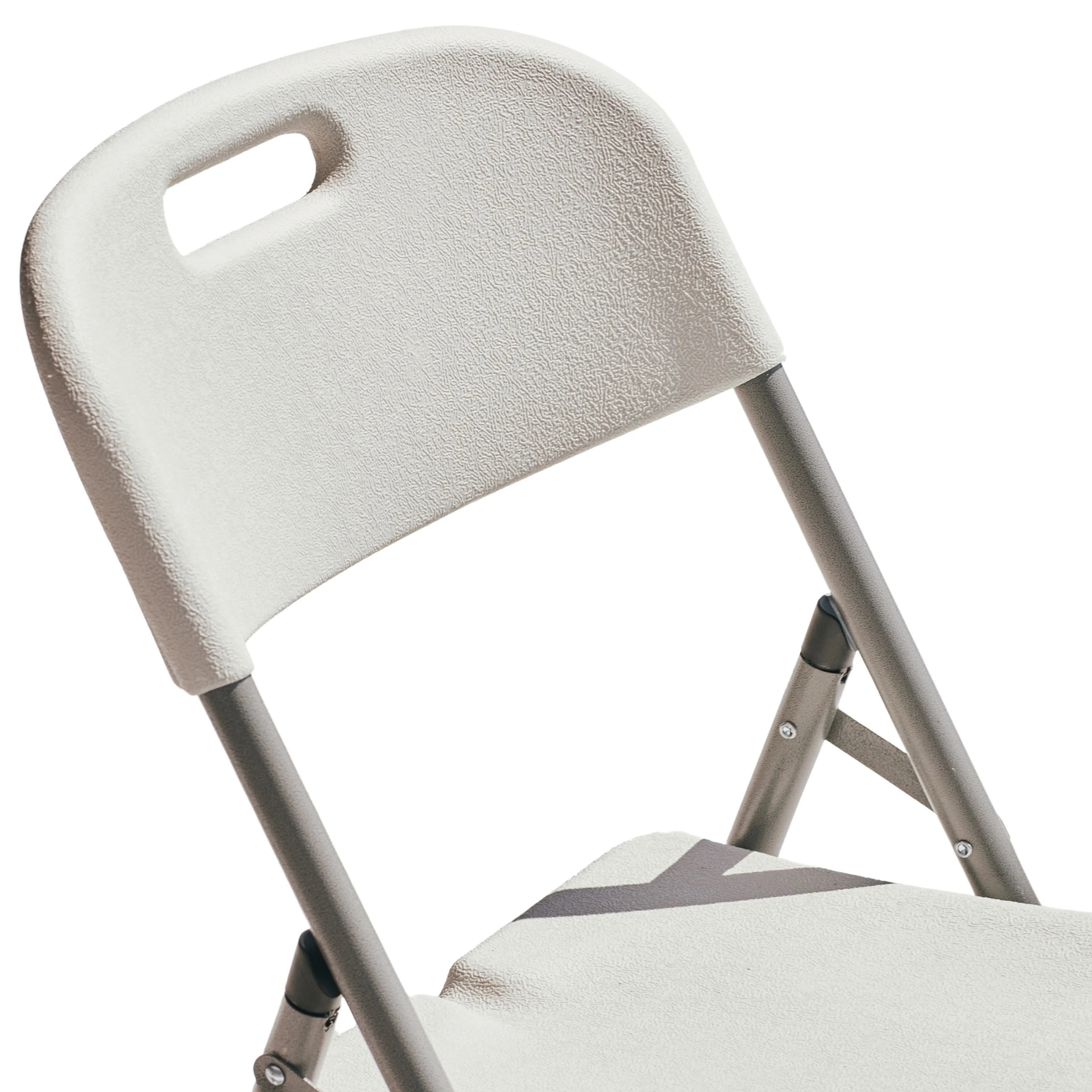 close up of white folding chair corner detail