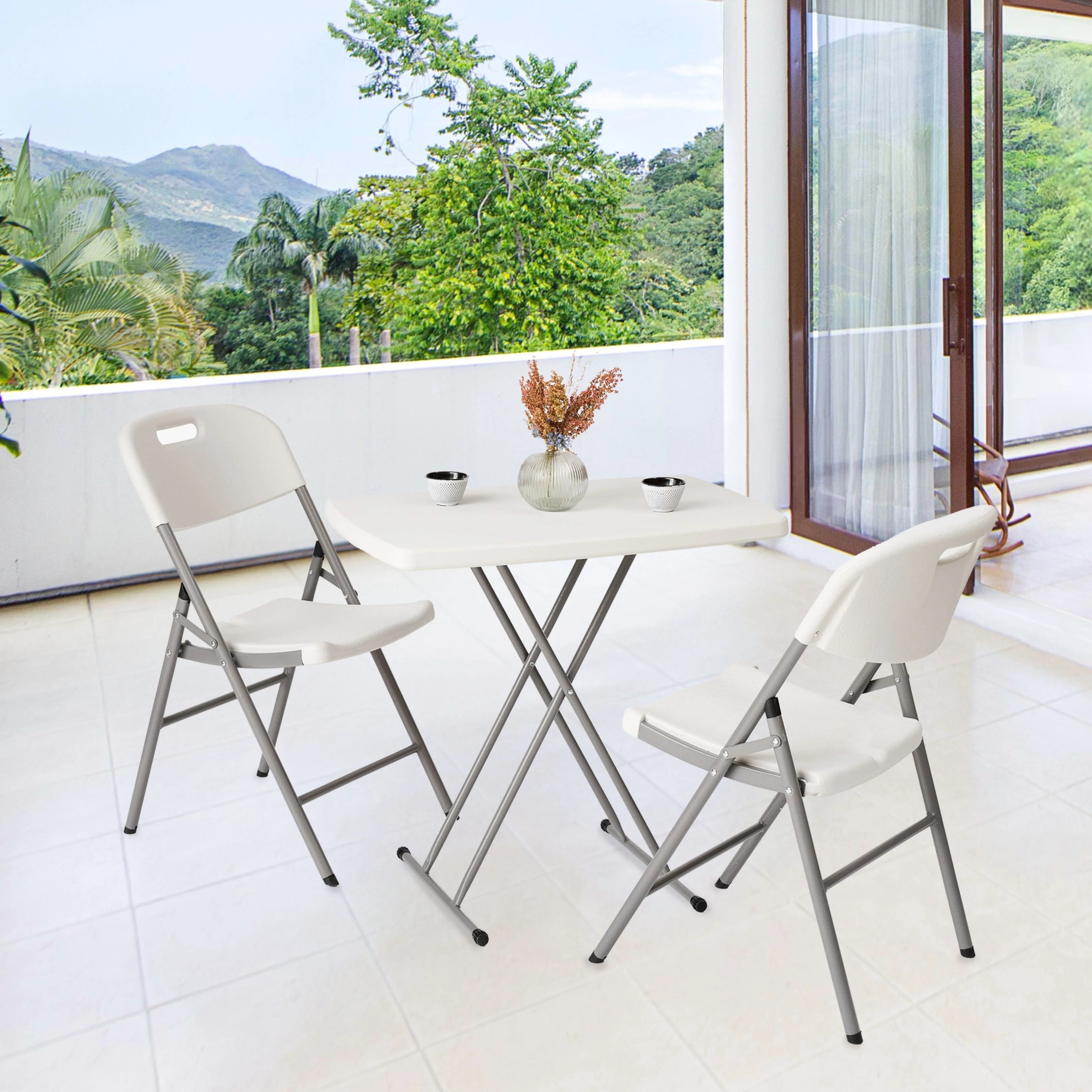 white folding chair and table in use at a veranda