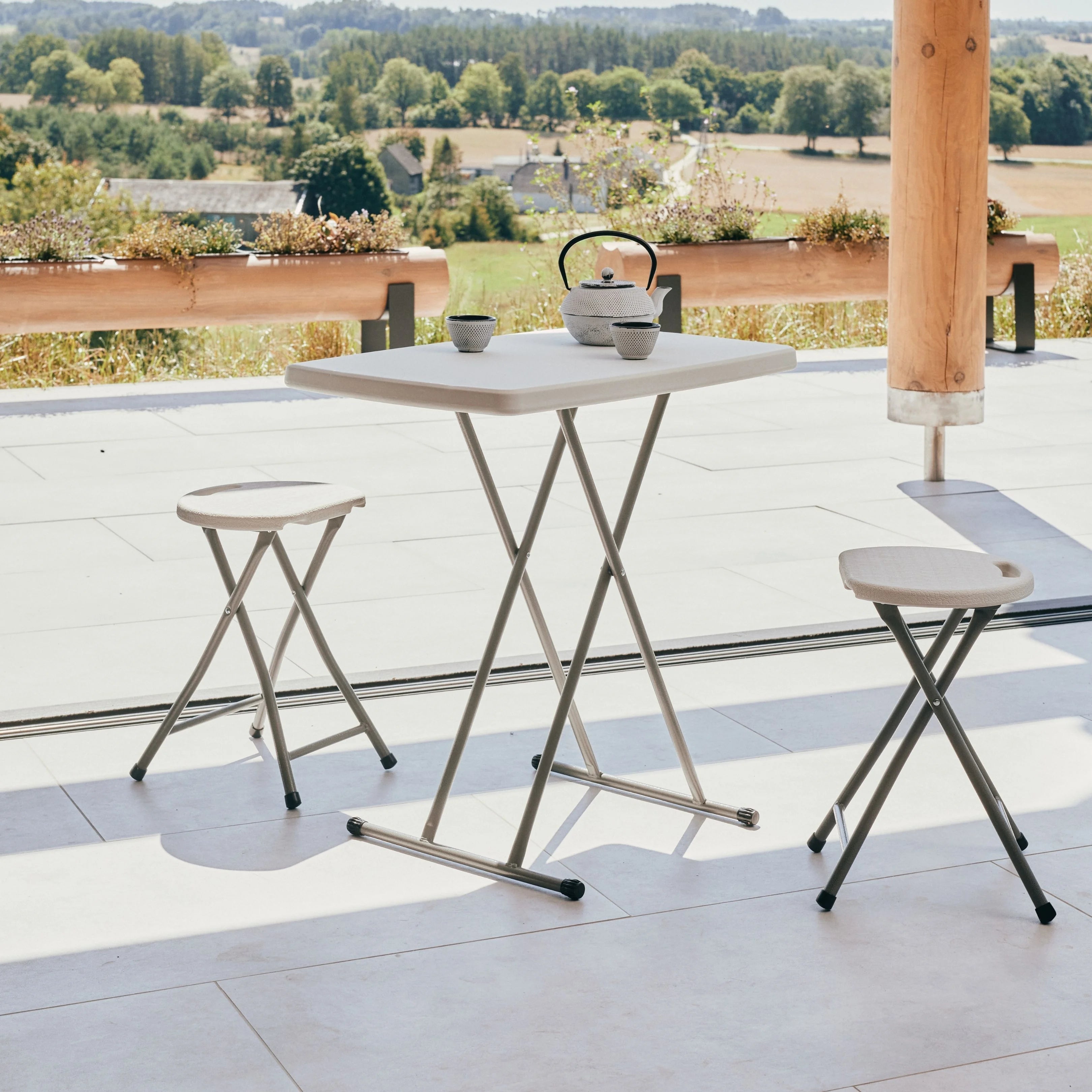 white folding stool and table in a scenic view