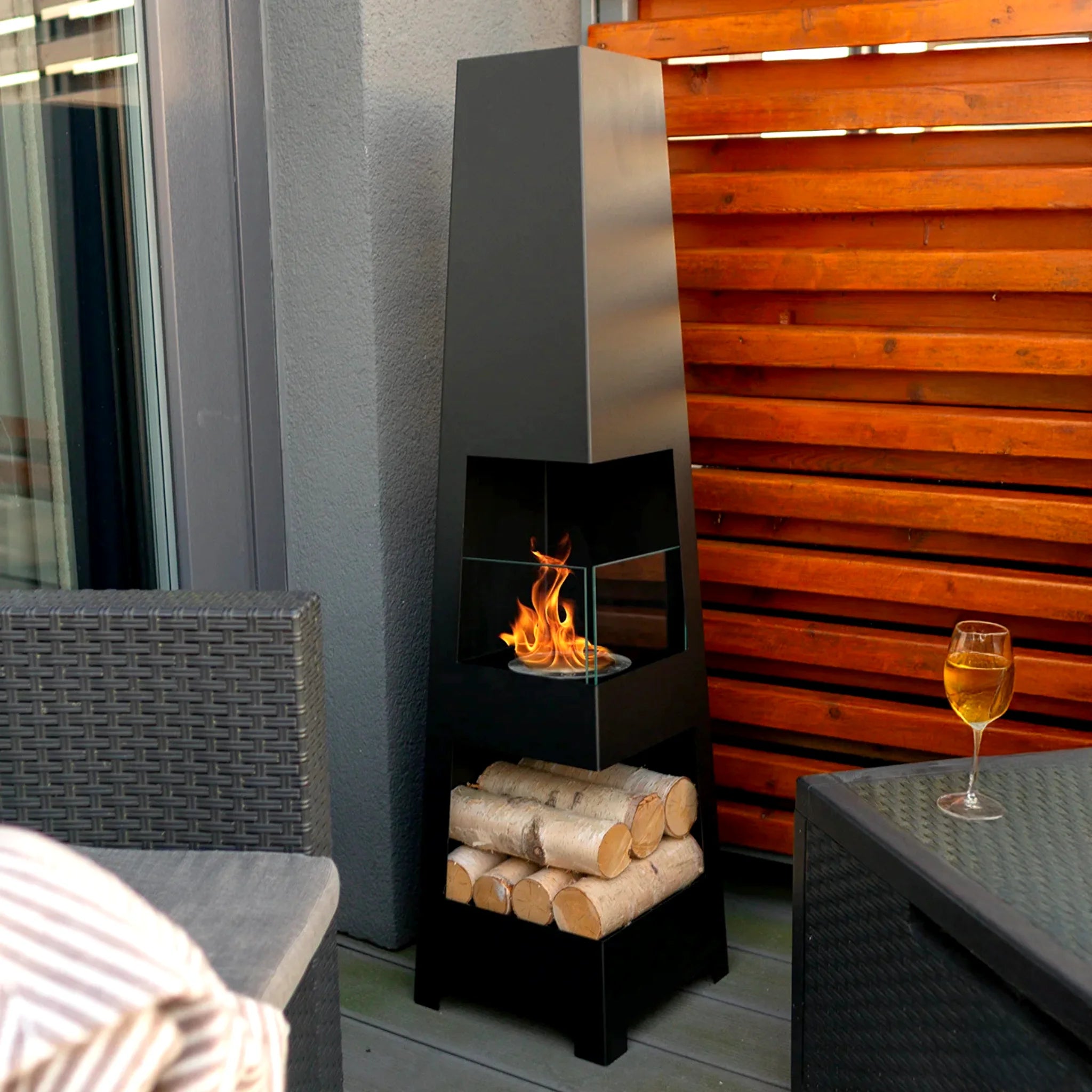 portable fireplace featuring logs and decorative plants for cozy living room