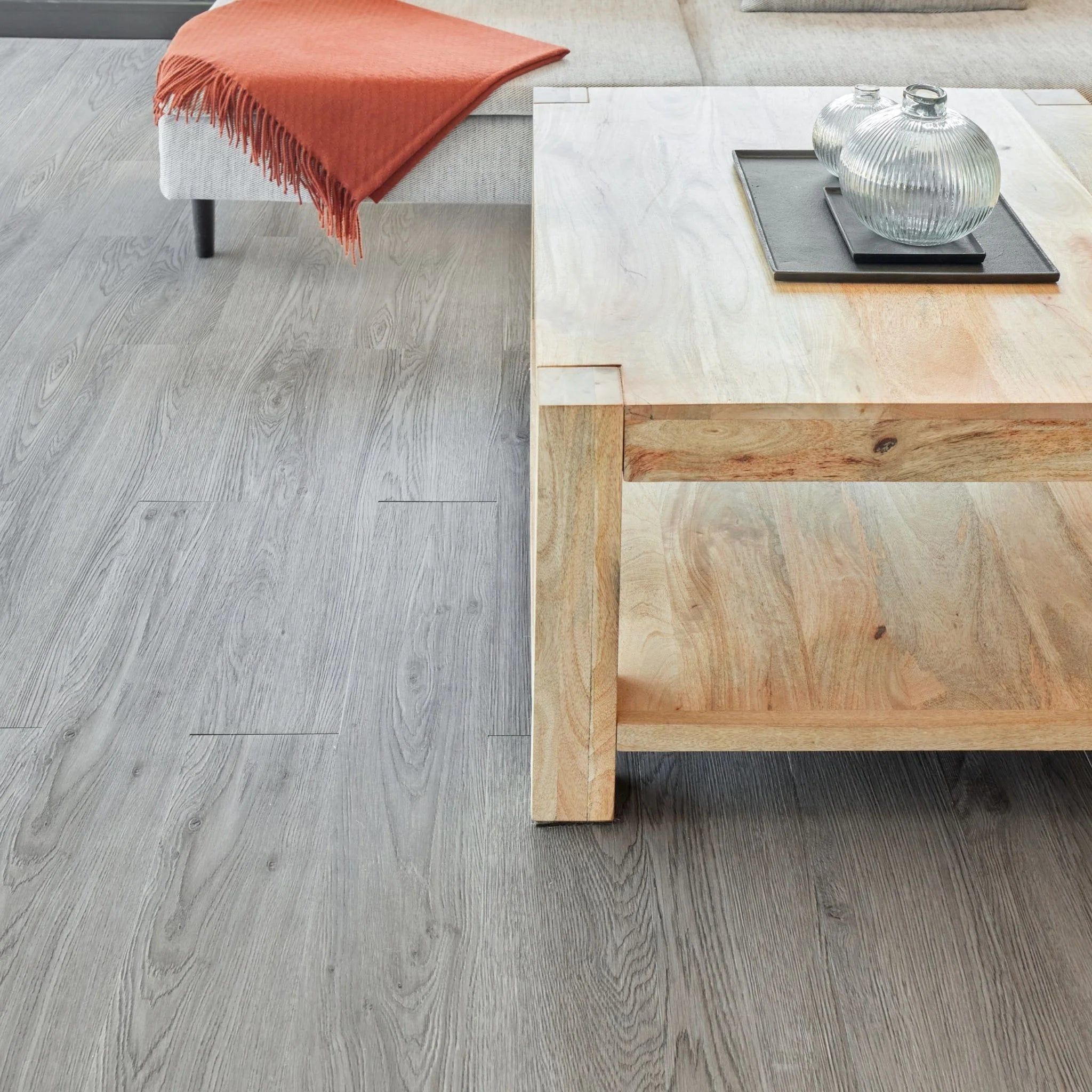spacious living room with rustic furniture and dark grey wood-effect vinyl flooring