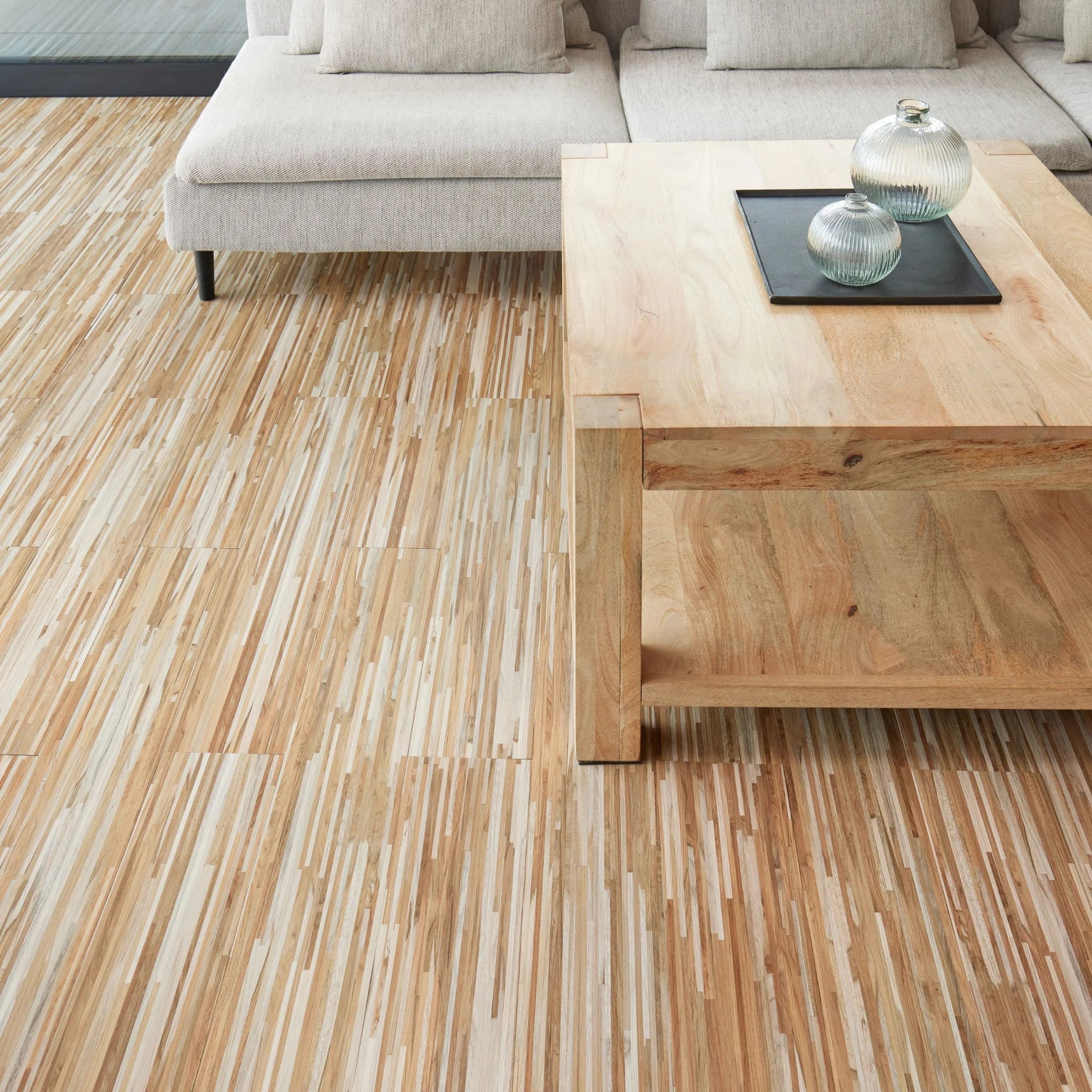 modern living room featuring grey sofa and light wood furniture on beige flooring
