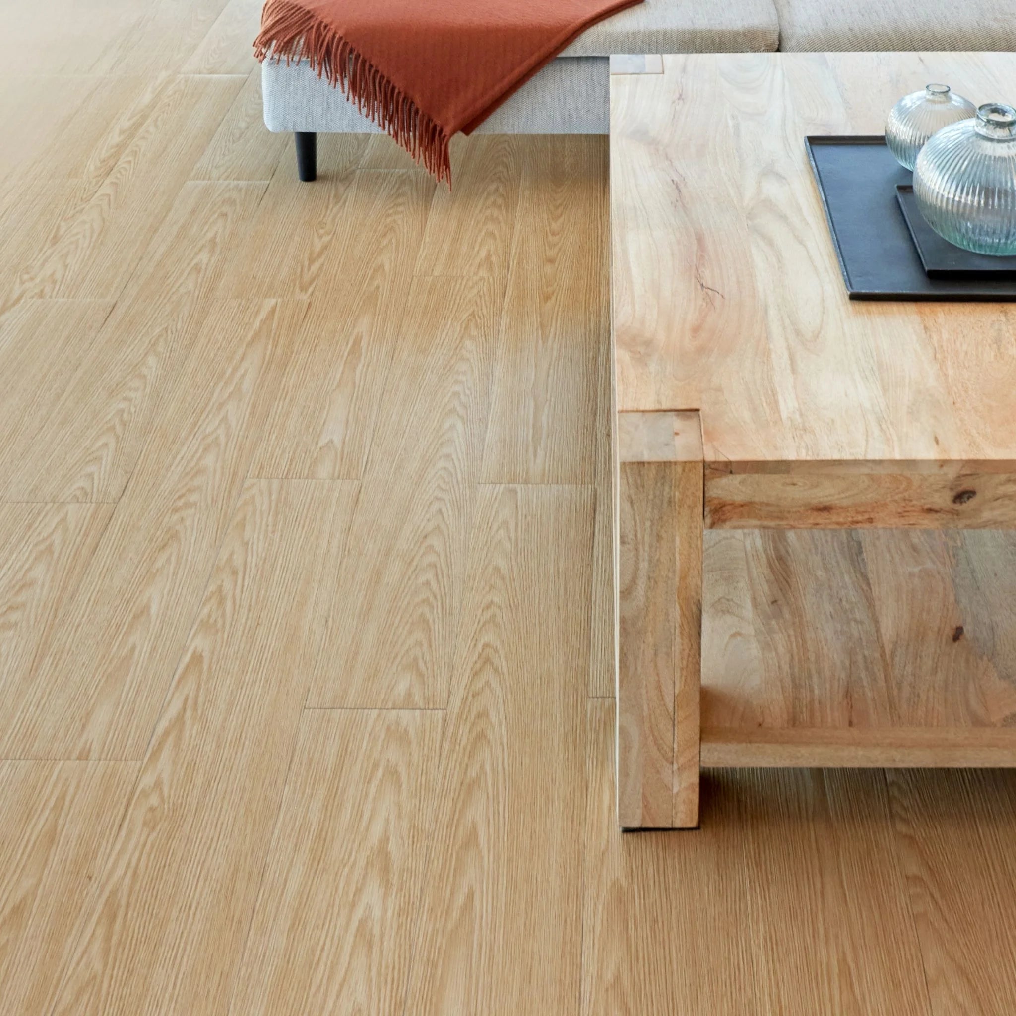 spacious living room with rustic furniture and light brown wood-effect vinyl flooring
