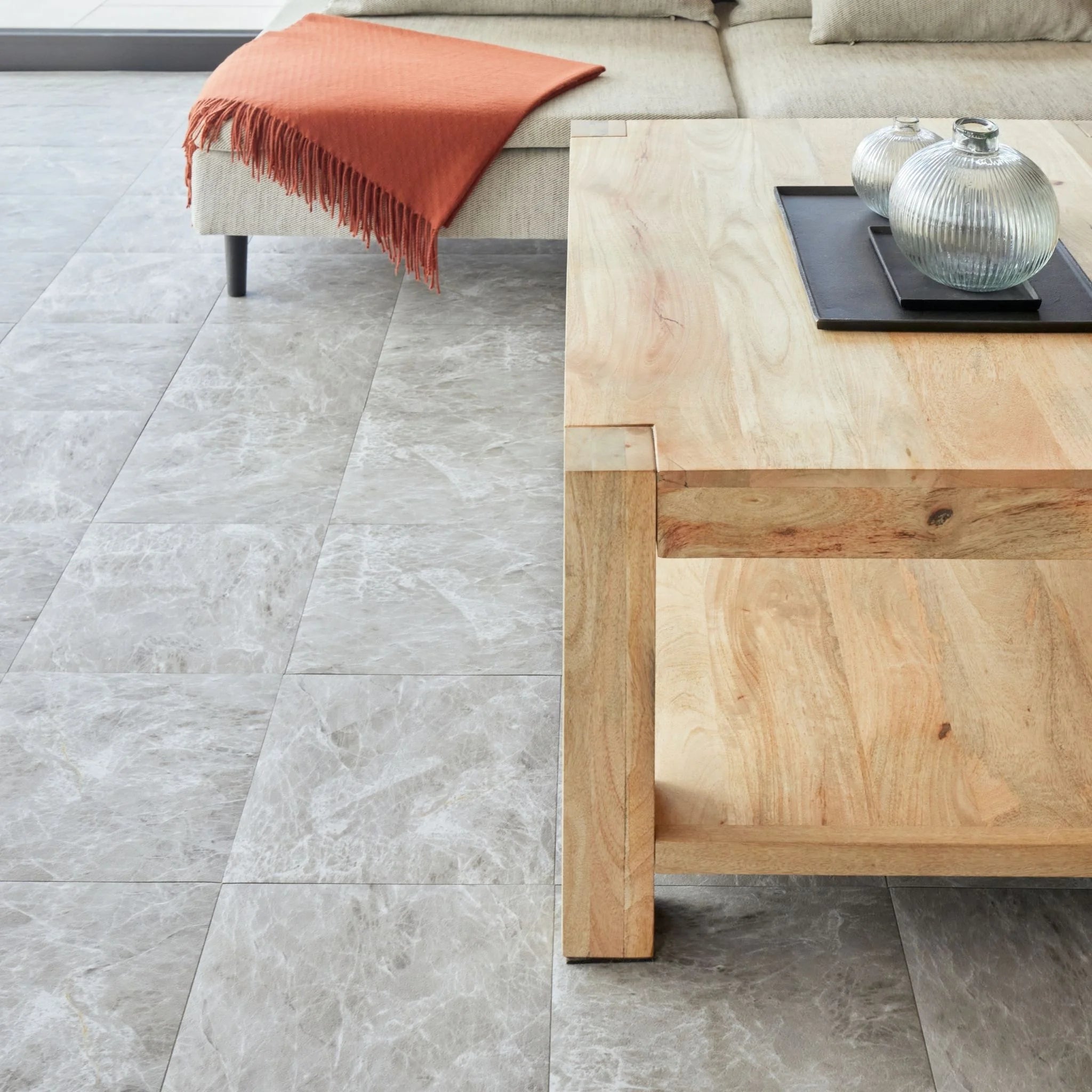 spacious living room with rustic furniture and light grey tile-effect concrete flooring