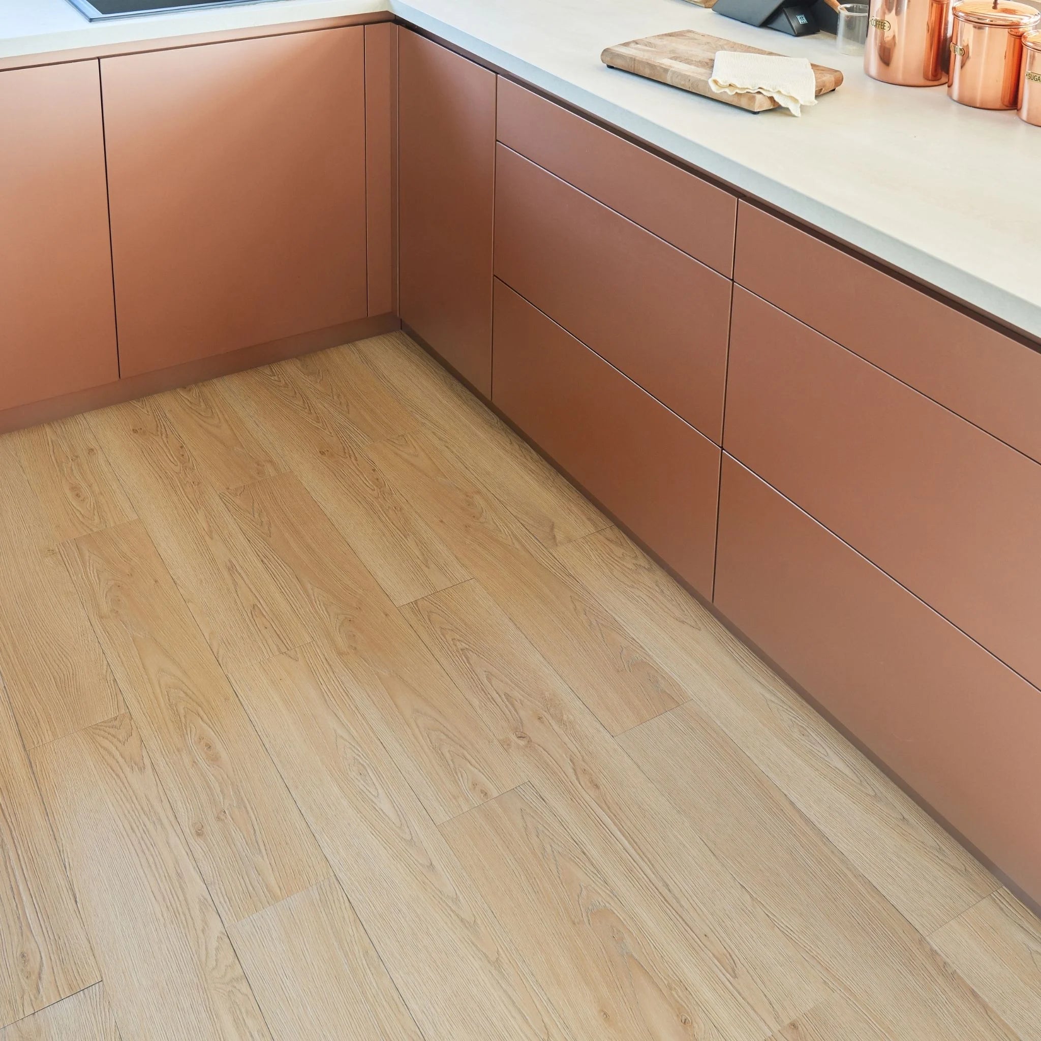 modern kitchen corner with brown cabinets and light brown wood-effect flooring