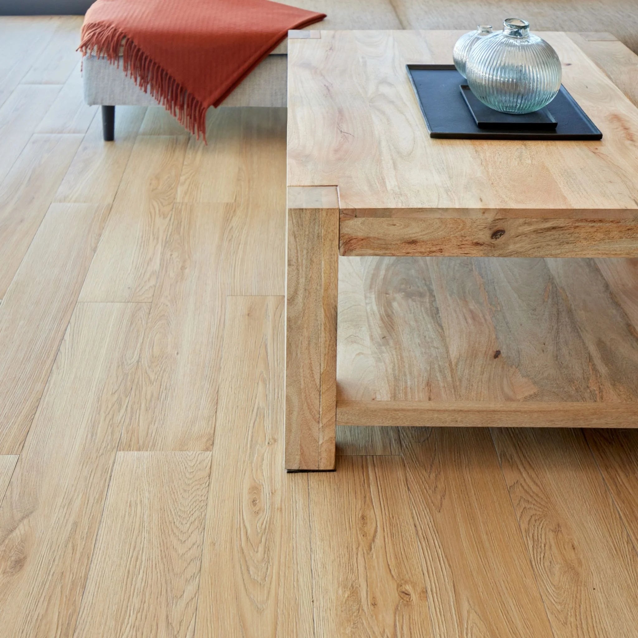 spacious living room with rustic furniture and light brown wood-effect vinyl flooring