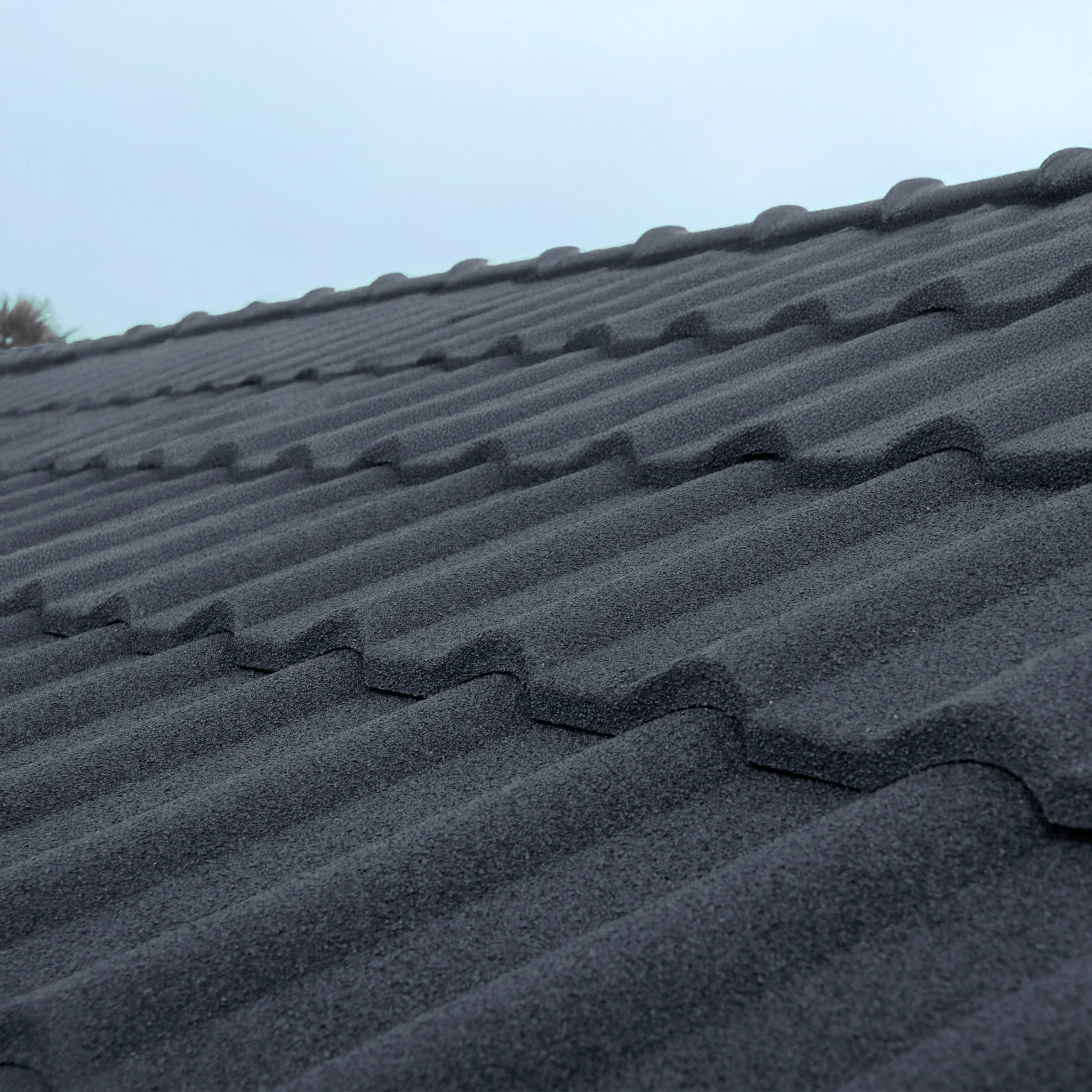 detailed view of a graphite roof shingles with a basalt stone coating