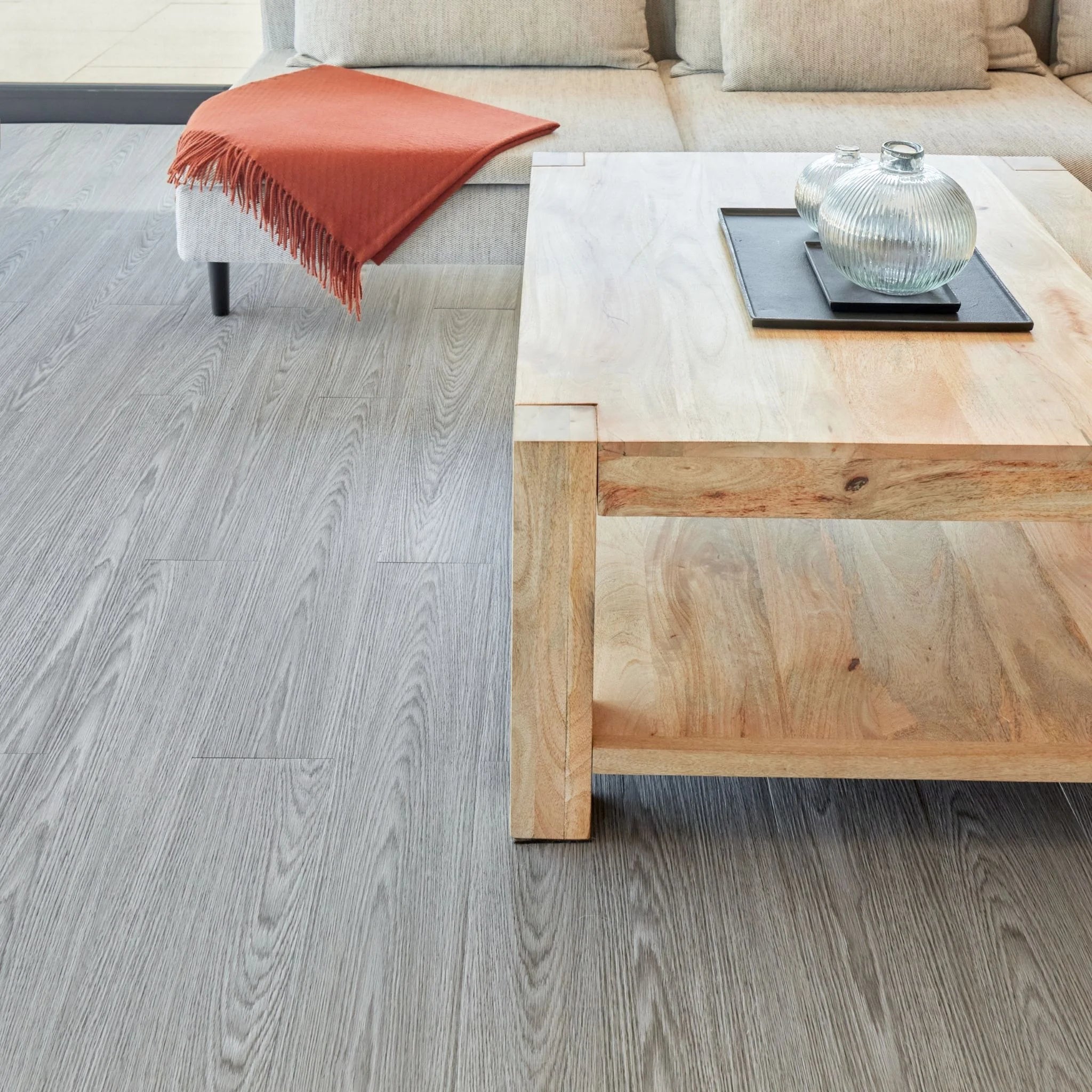 spacious living room with rustic furniture and light grey wood-effect vinyl flooring