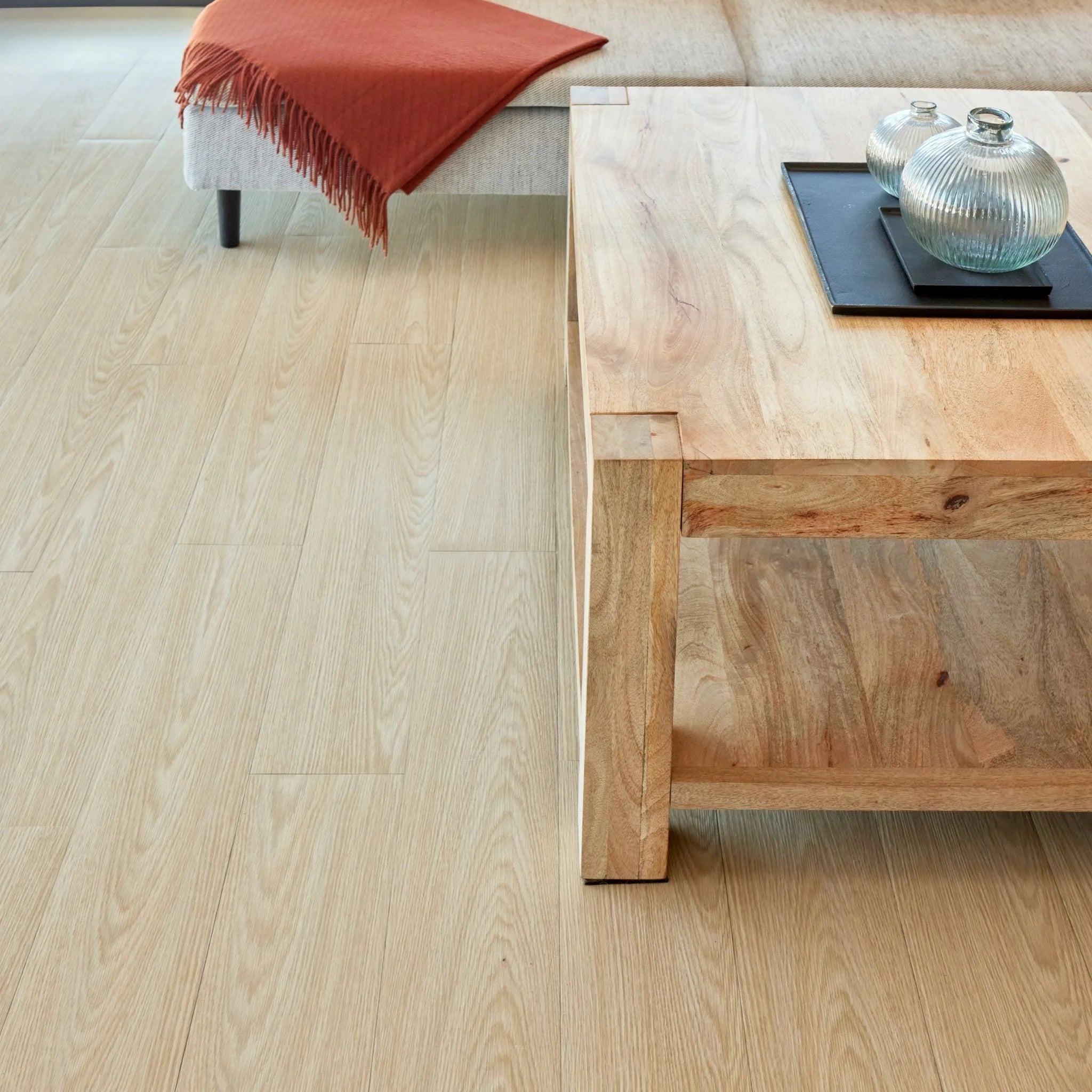 spacious living room with rustic furniture and natural beige wood-effect vinyl flooring