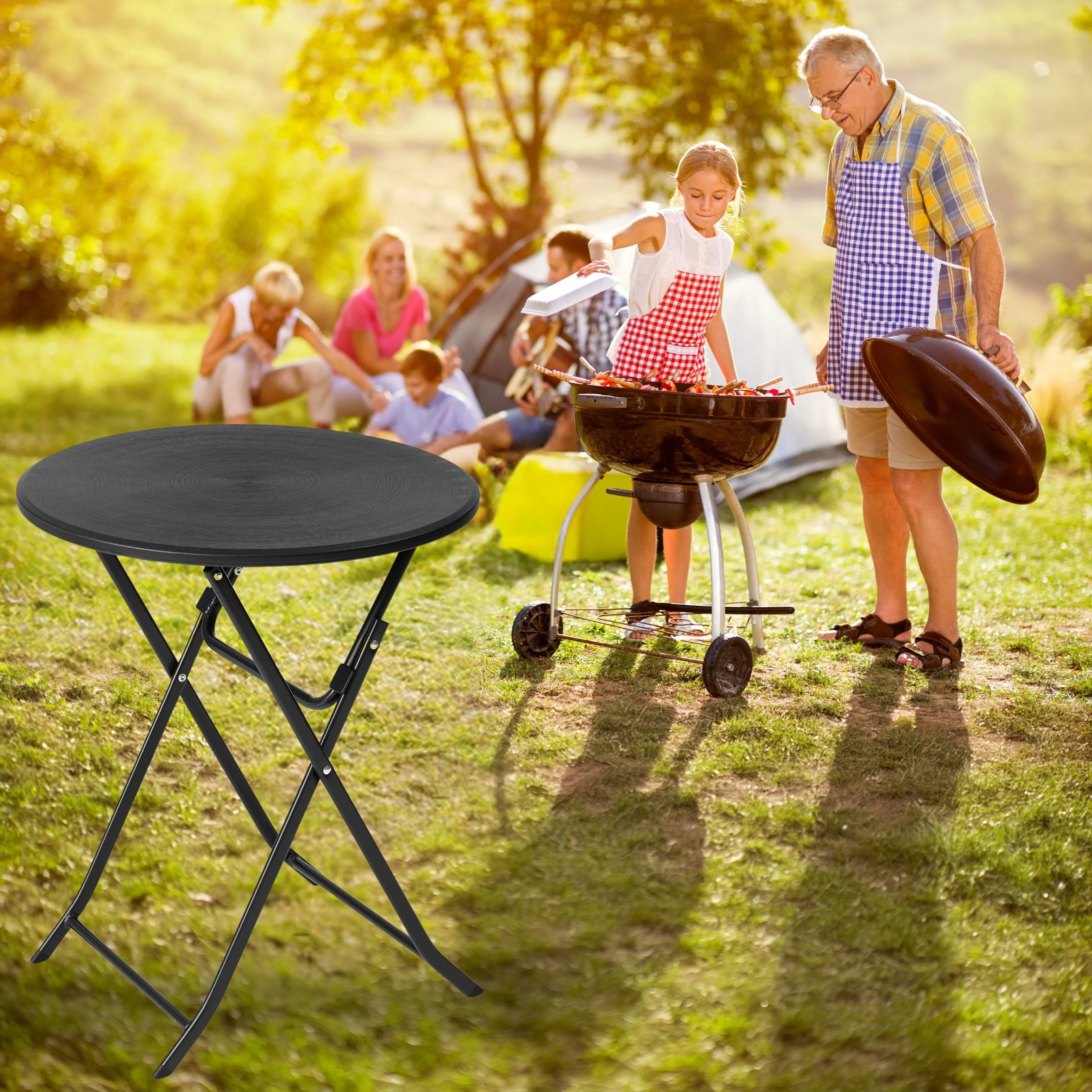 black round folding table in use at outdoor barbecue