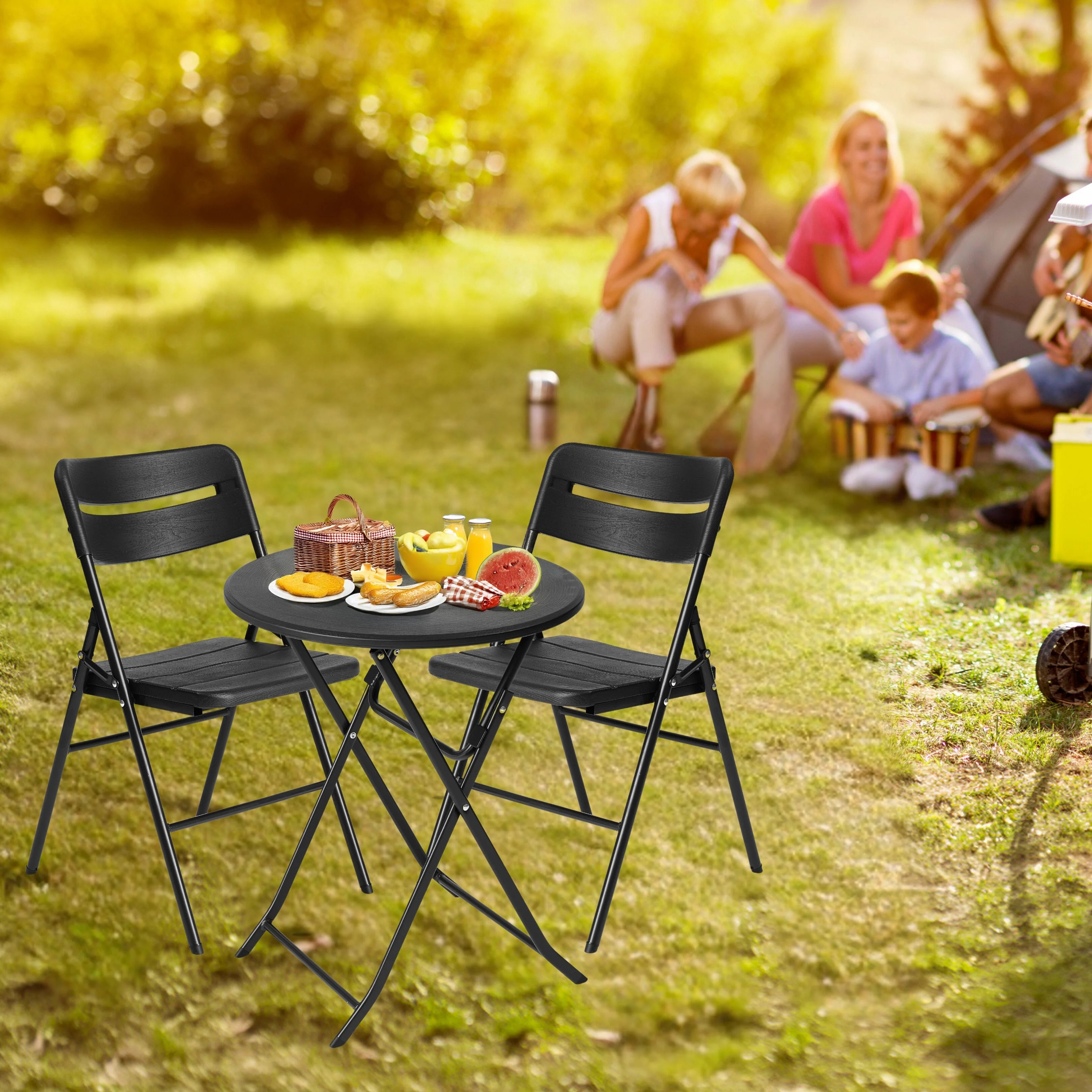 black round folding table and chair in use at outdoor barbecue