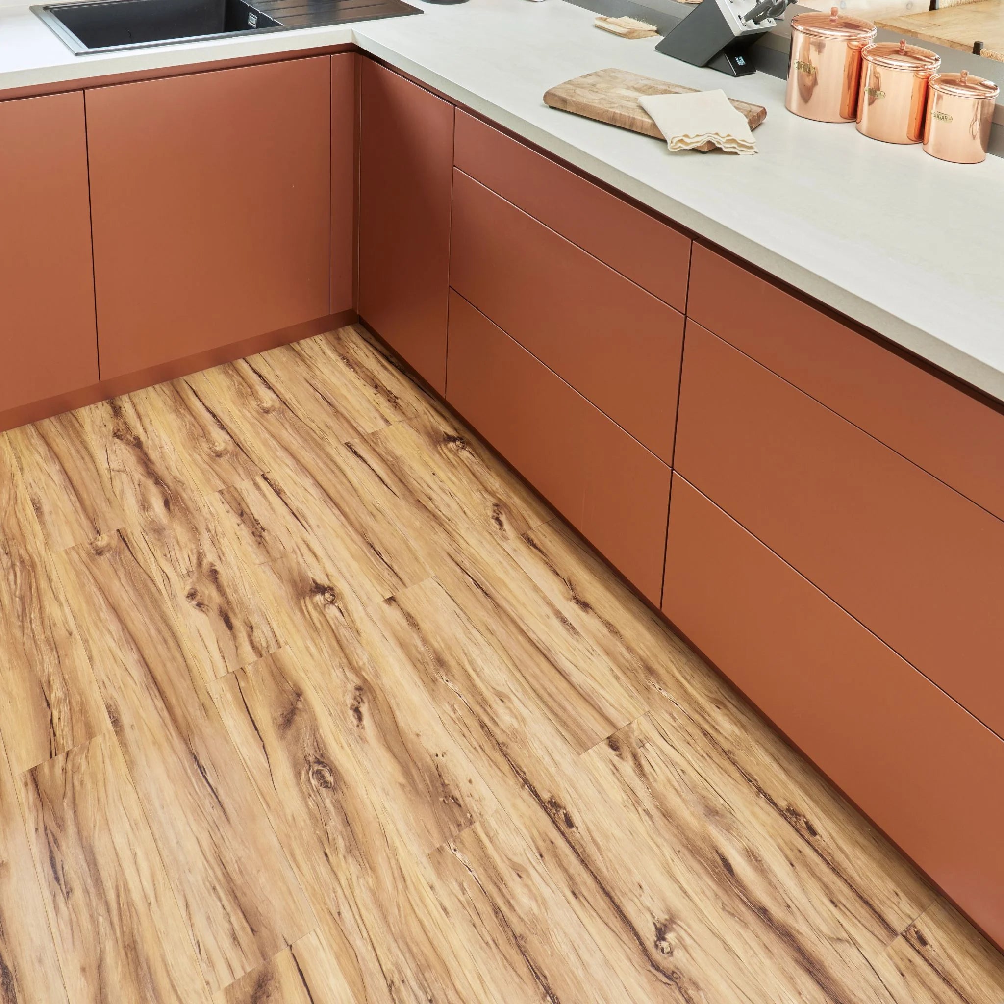 contemporary kitchen featuring brown kitchen furniture with light dark flooring