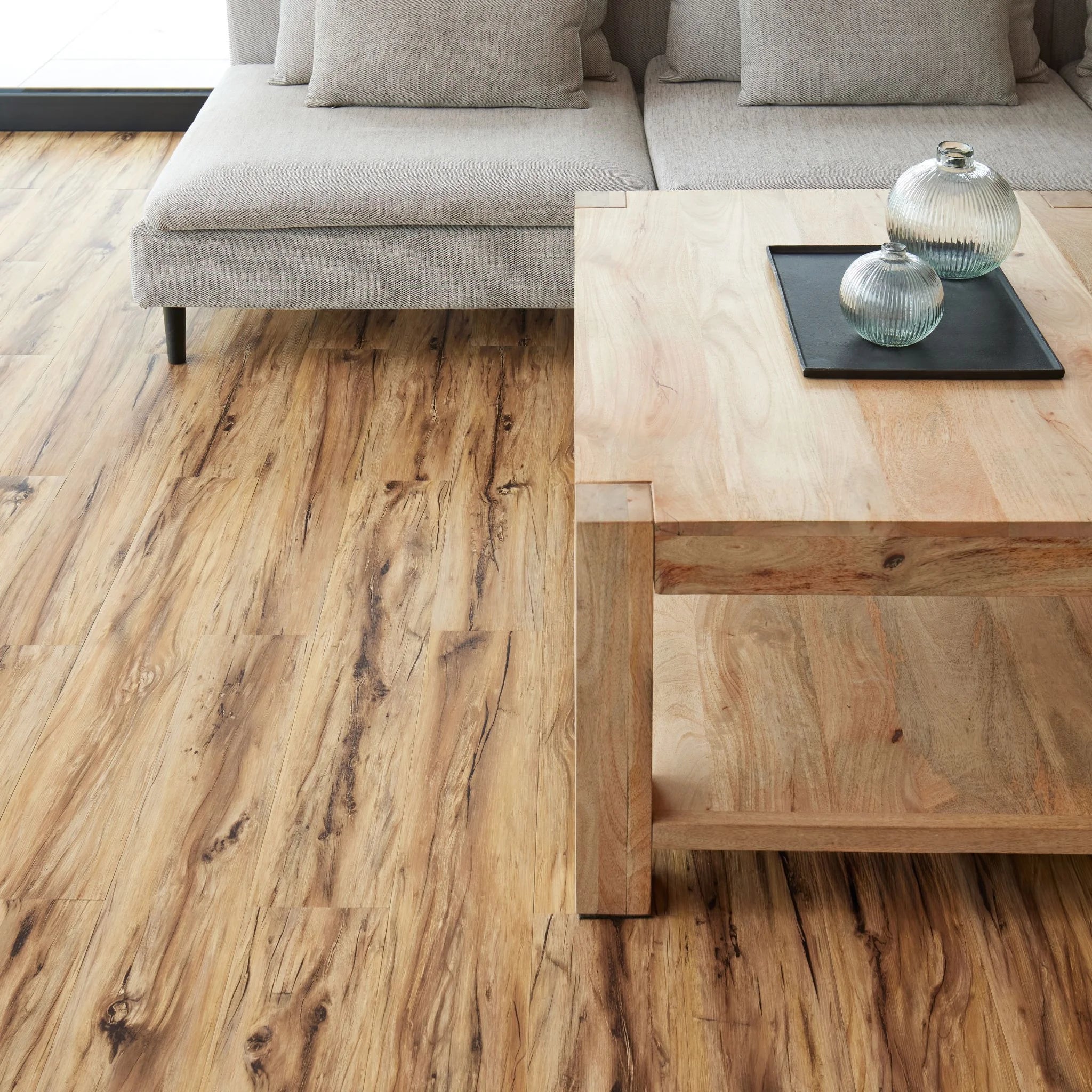 modern living room featuring grey sofa and light wood furniture on natural timber look flooring
