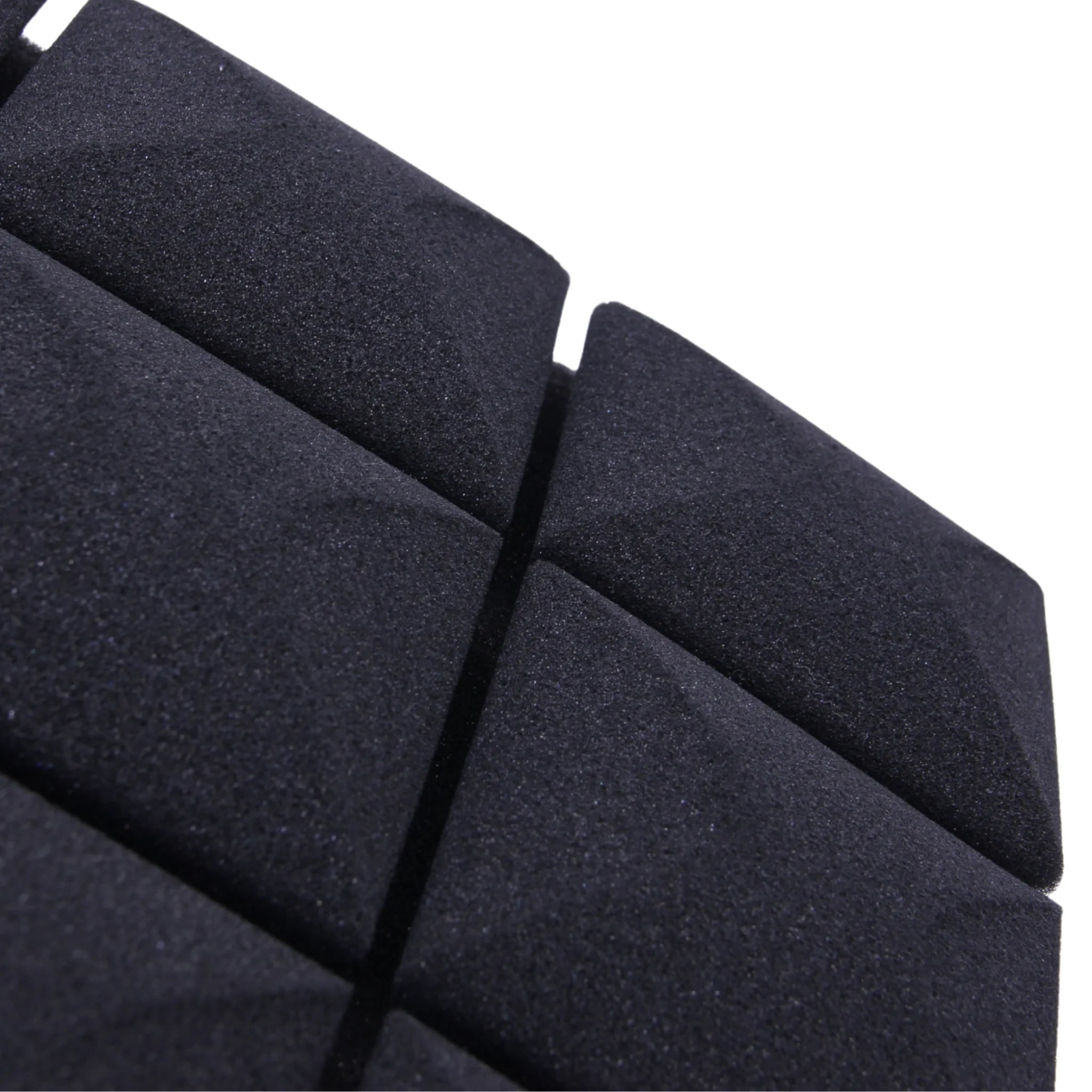 A close-up of a black triangular foam panel non-toxic material