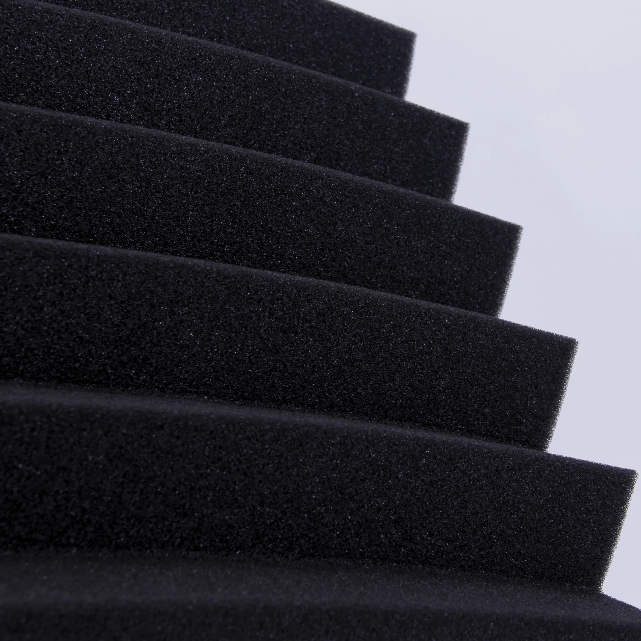 A close-up of a black triangular foam panel non-toxic material