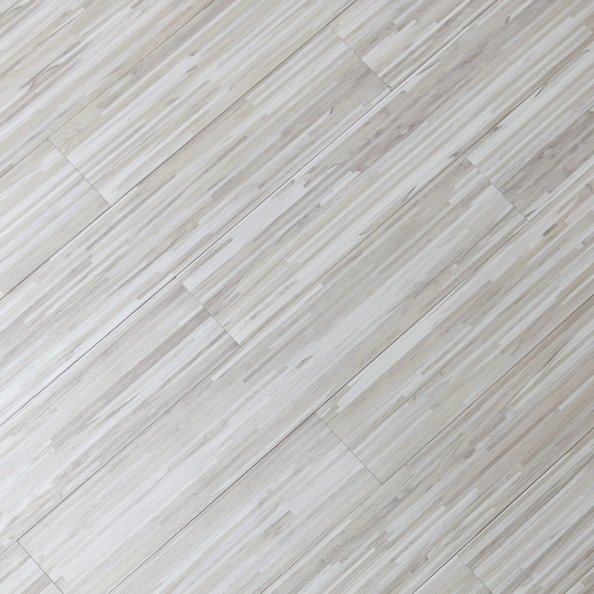 close-up of a wood-effect vinyl plank in stripped light grey tones