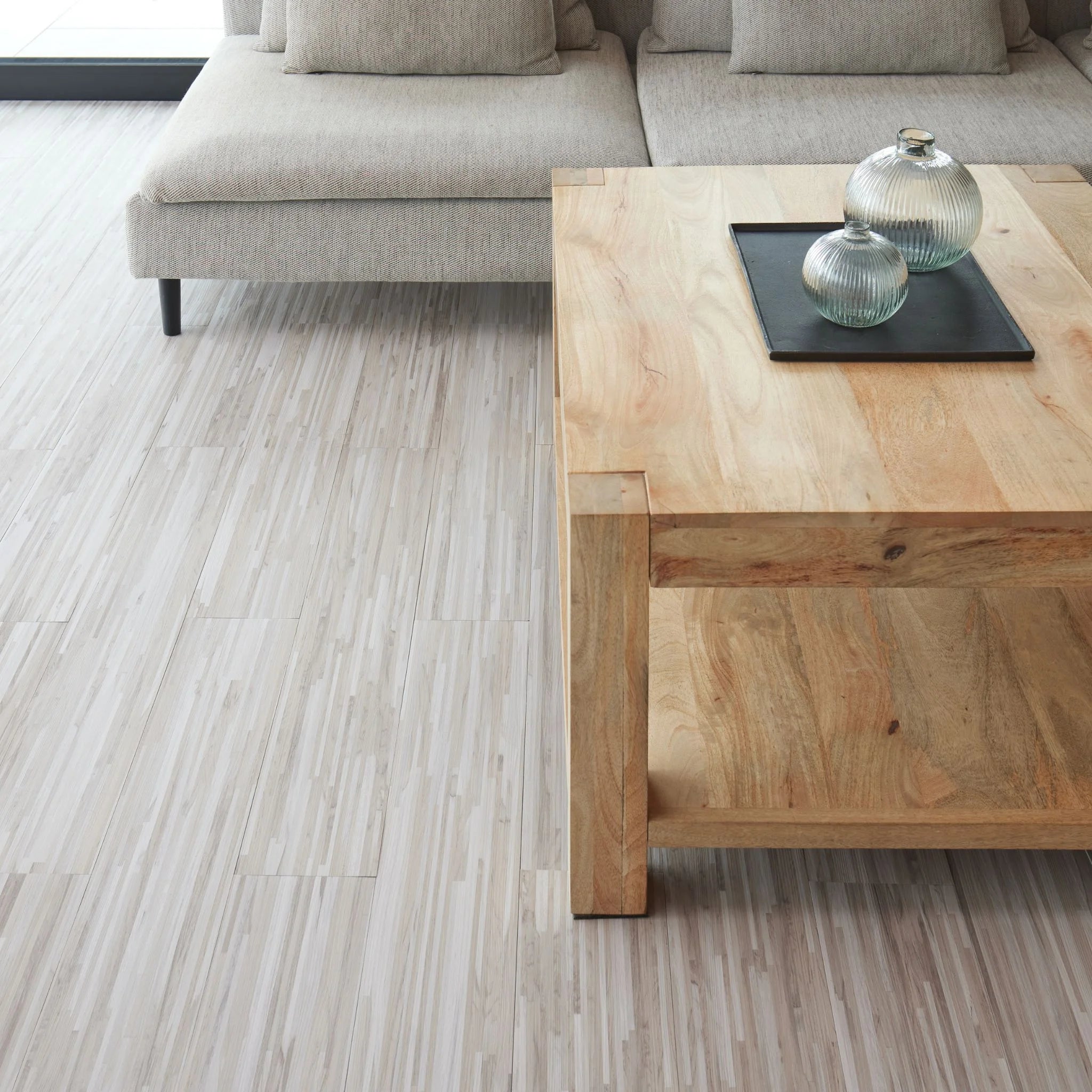 modern living room featuring grey sofa and light wood furniture on grey flooring