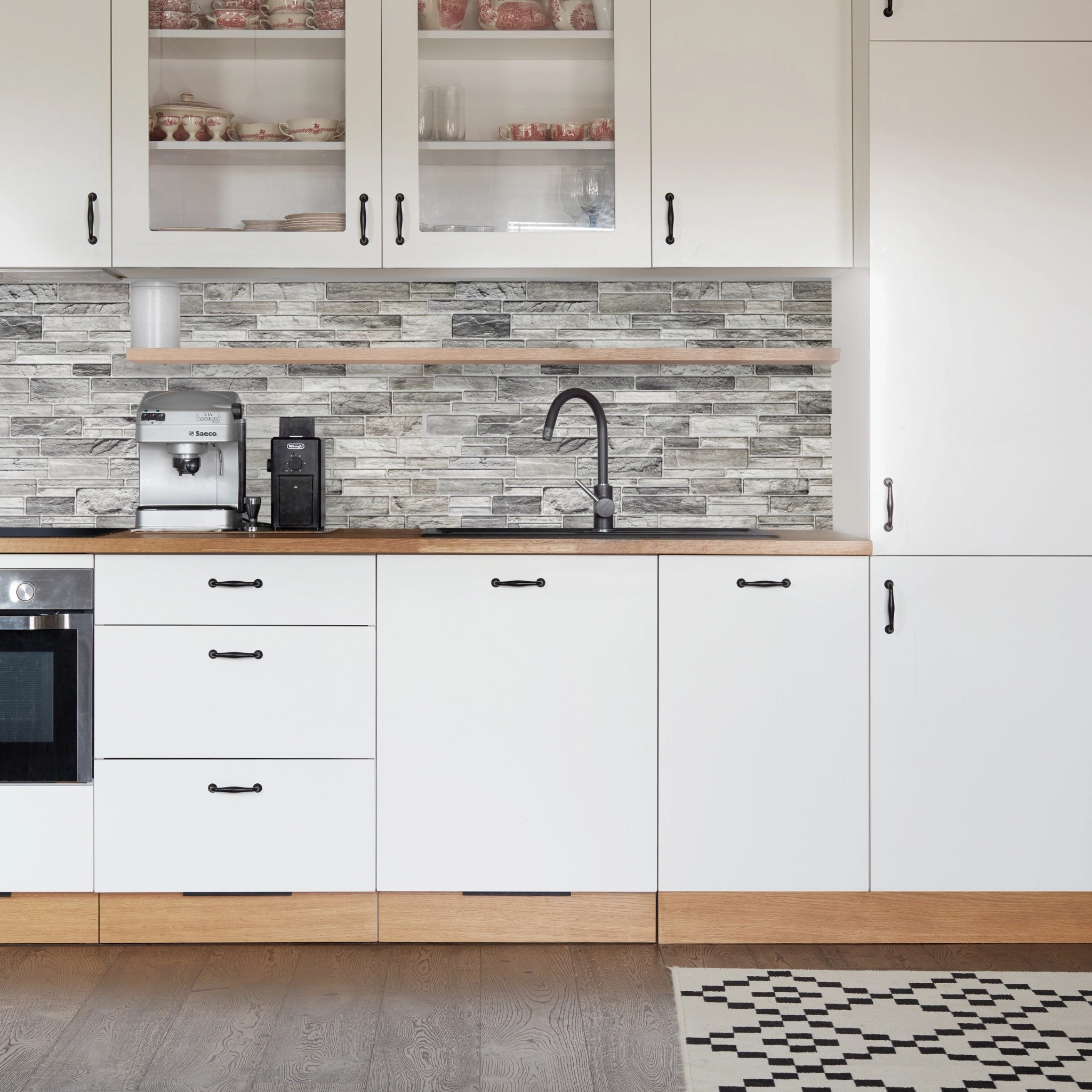 Kitchen with mix of grey, beige, & white geometric-patterned wall panels and modern decor