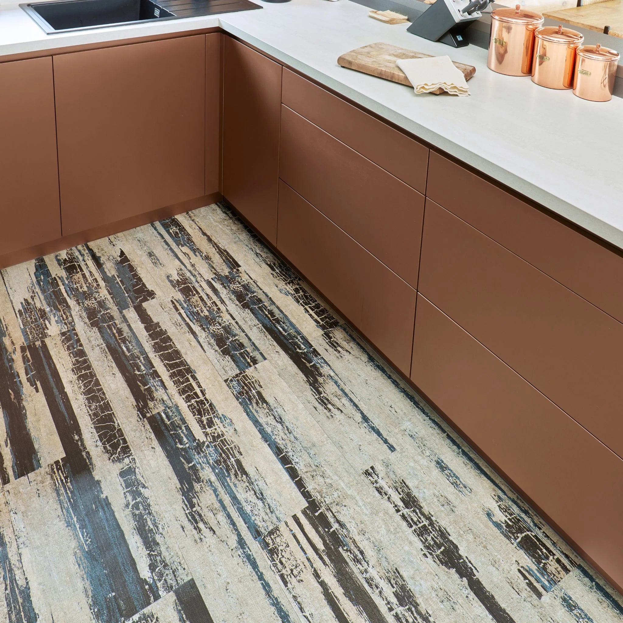 contemporary kitchen featuring brown kitchen furniture with light dark flooring