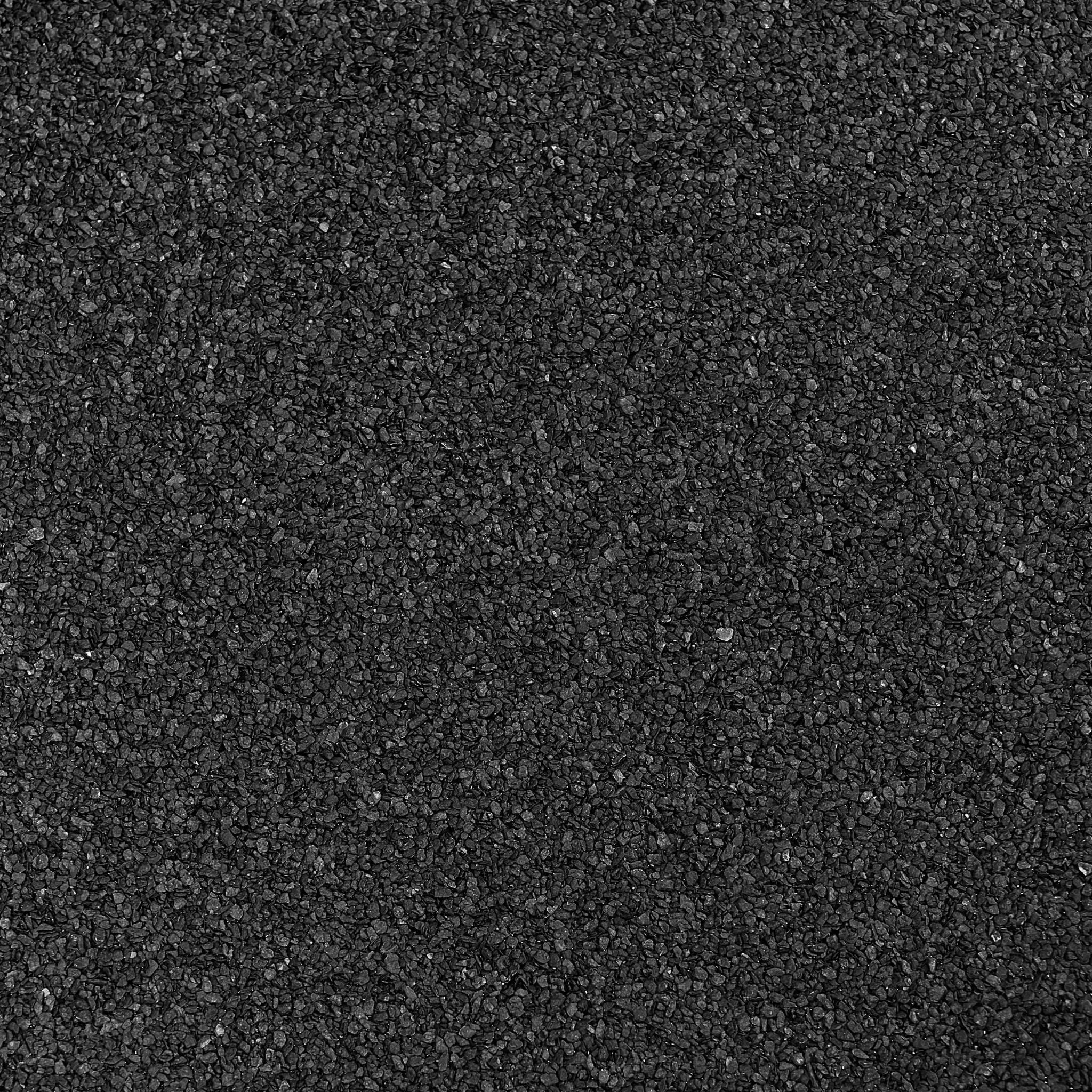 close-up view of black textured cap sheet roofing material showing its granular surface