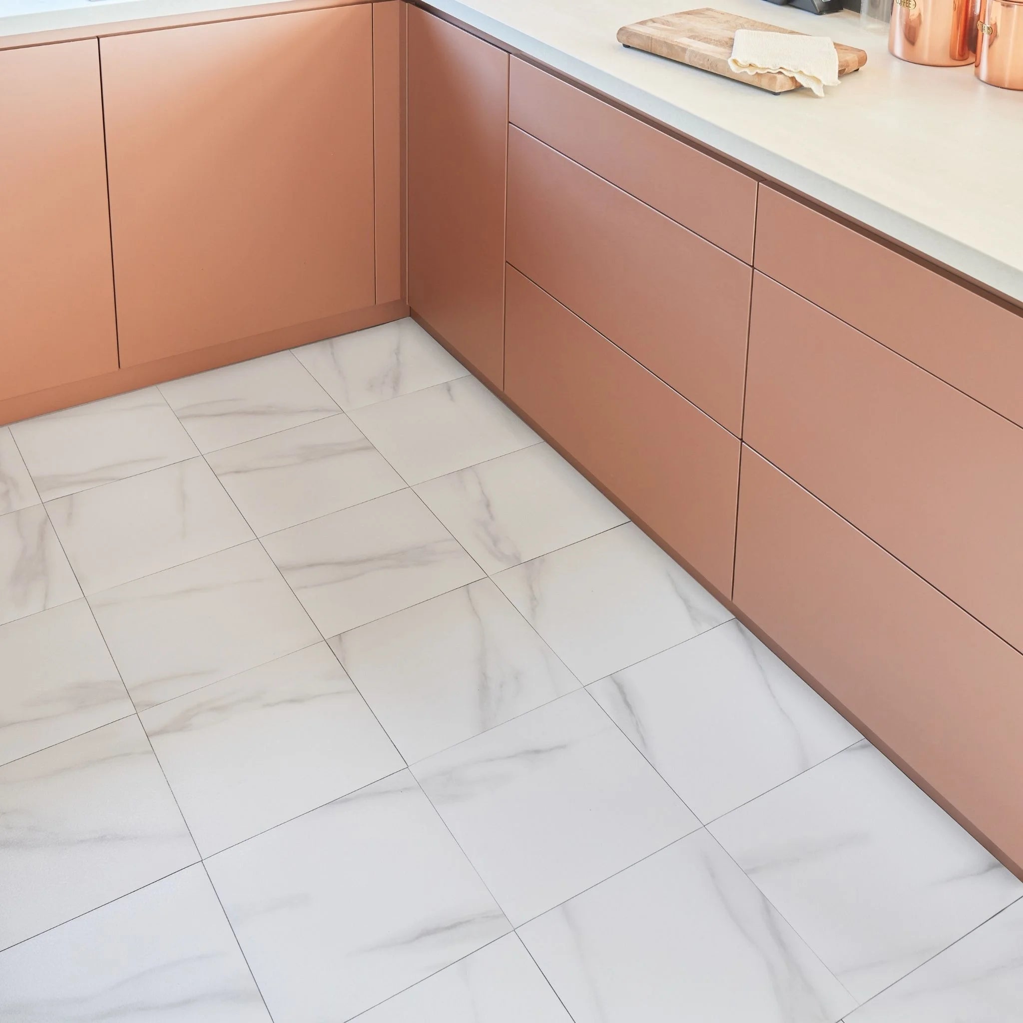 modern kitchen corner with brown cabinets and white tile-effect flooring