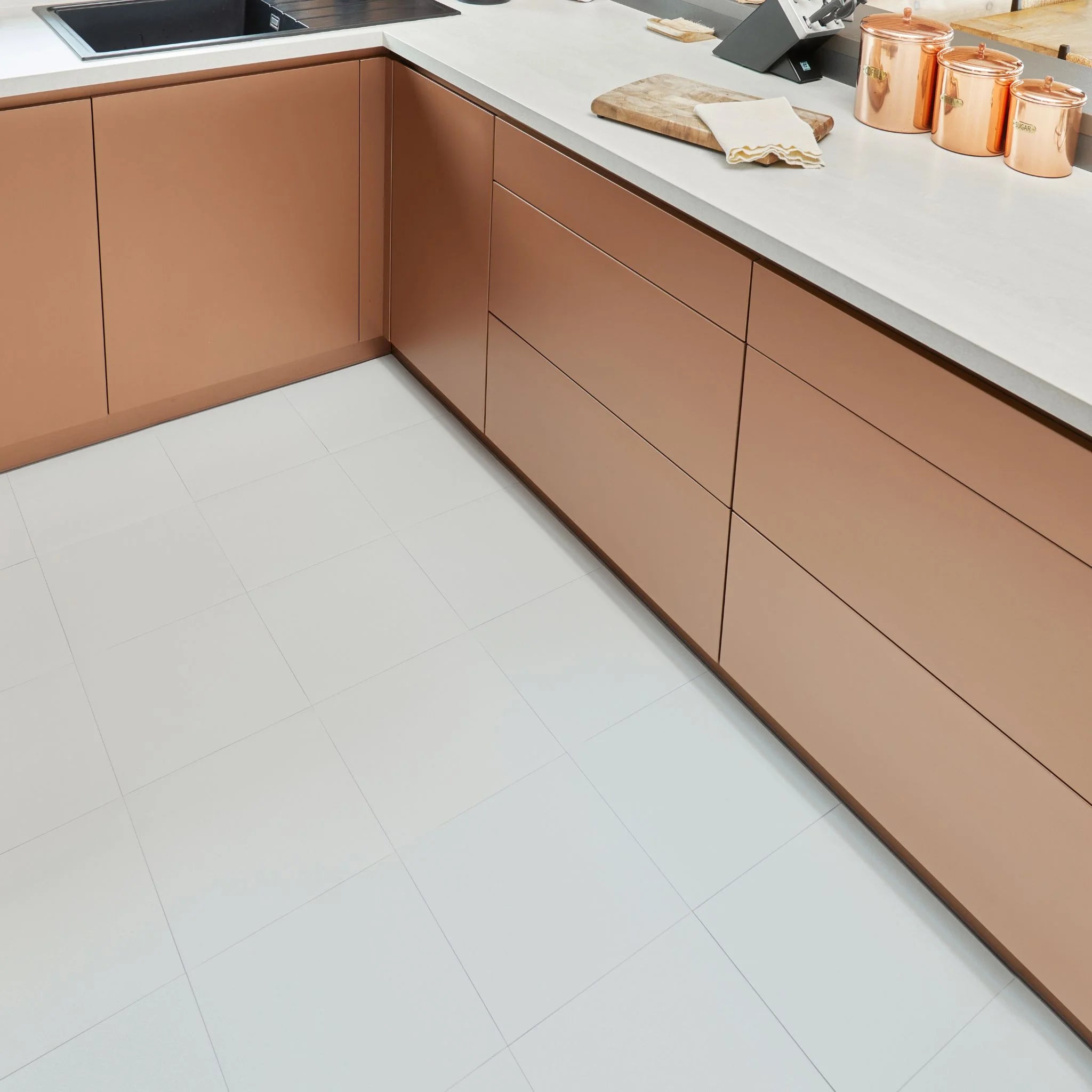 contemporary kitchen featuring brown kitchen furniture with white flooring