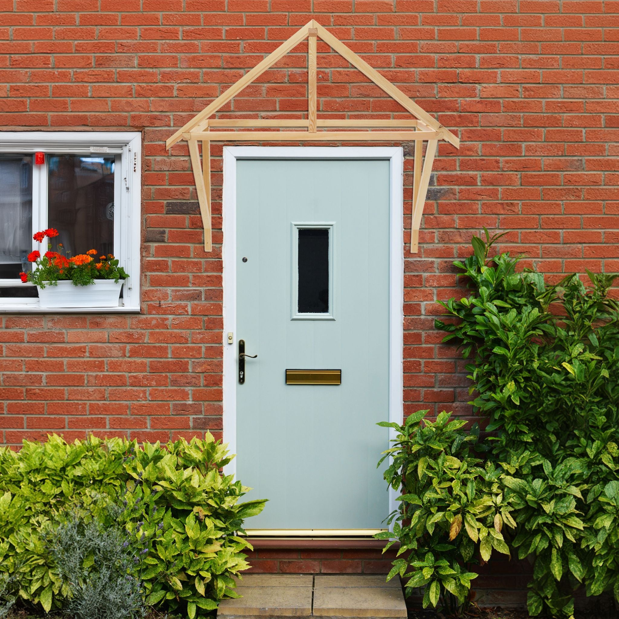 wooden door canopy above light blue door with brick wall
