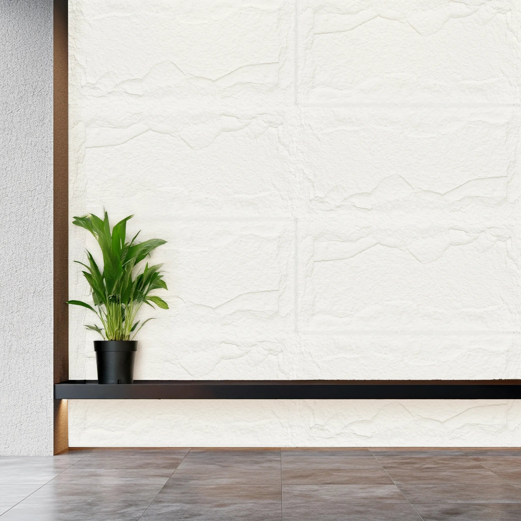 Faux stone wall panels ivory white with 3D texture behind shelf and plant in modern interior