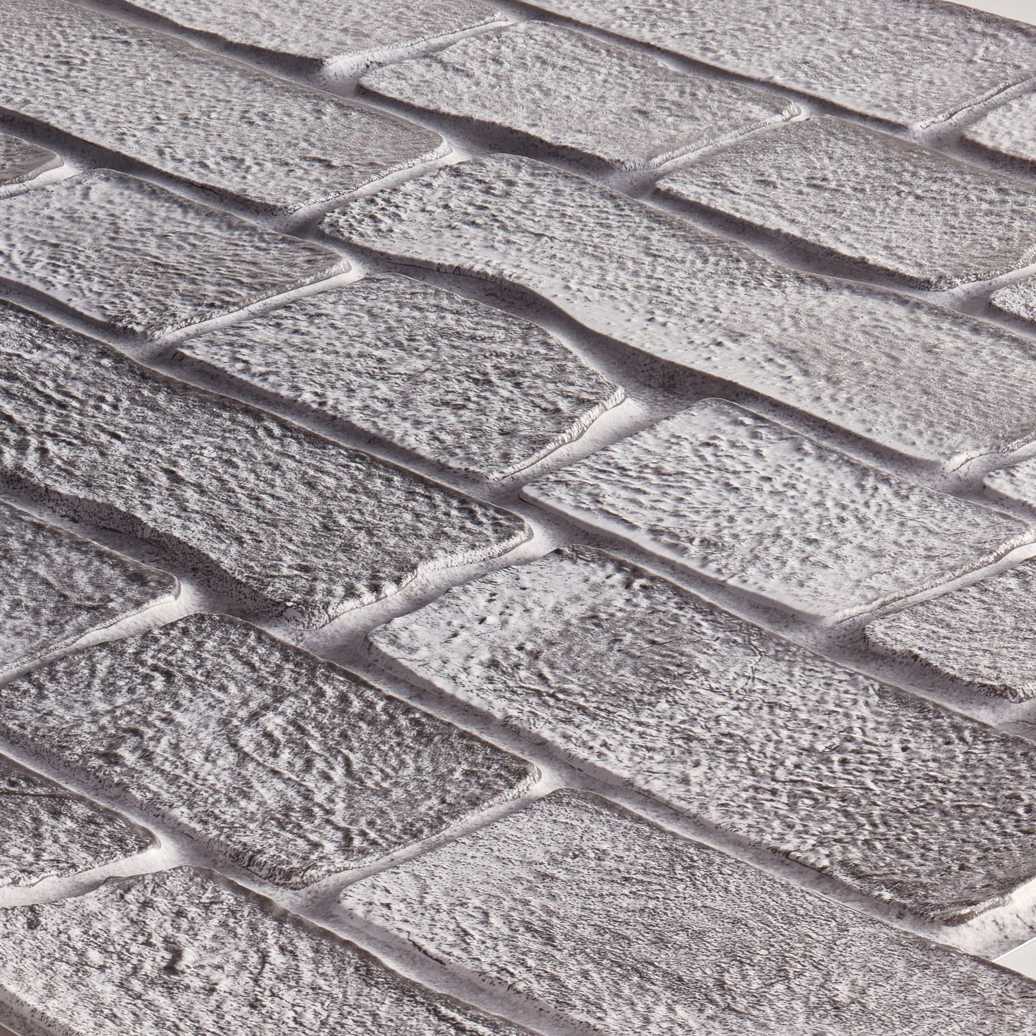 close-up of grey faux brick 3d wall panel texture