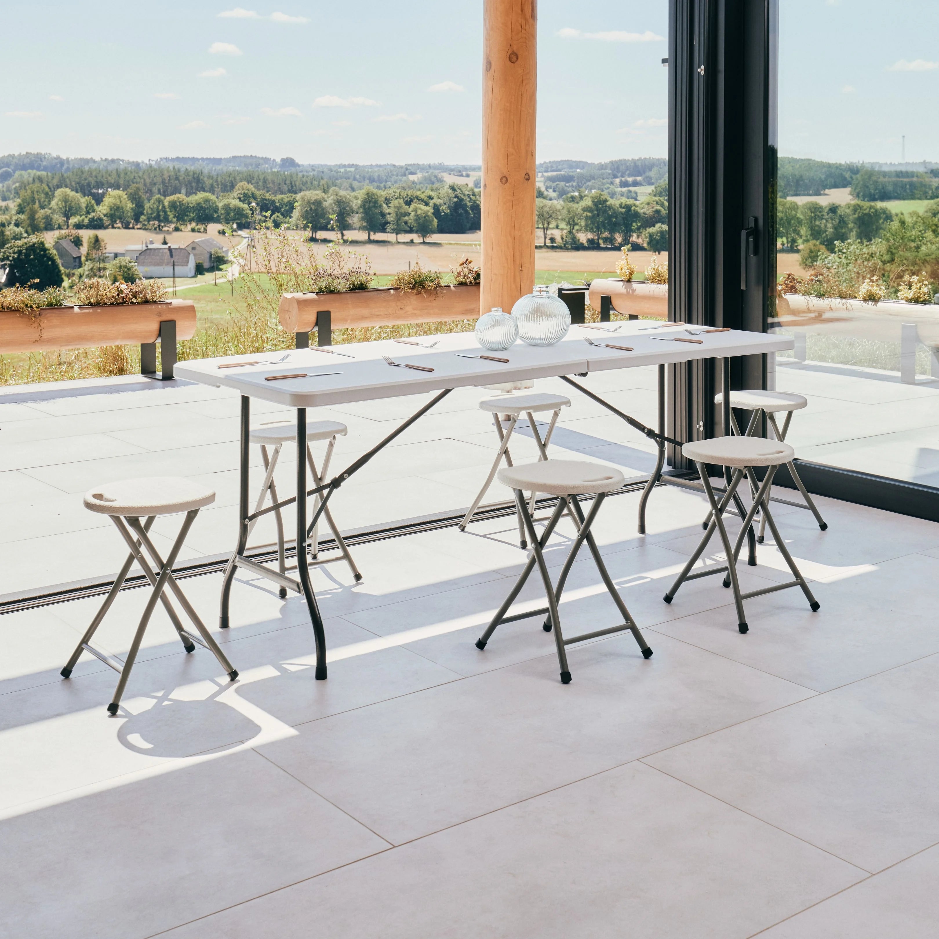 white 6ft folding table and stool on patio with scenic view