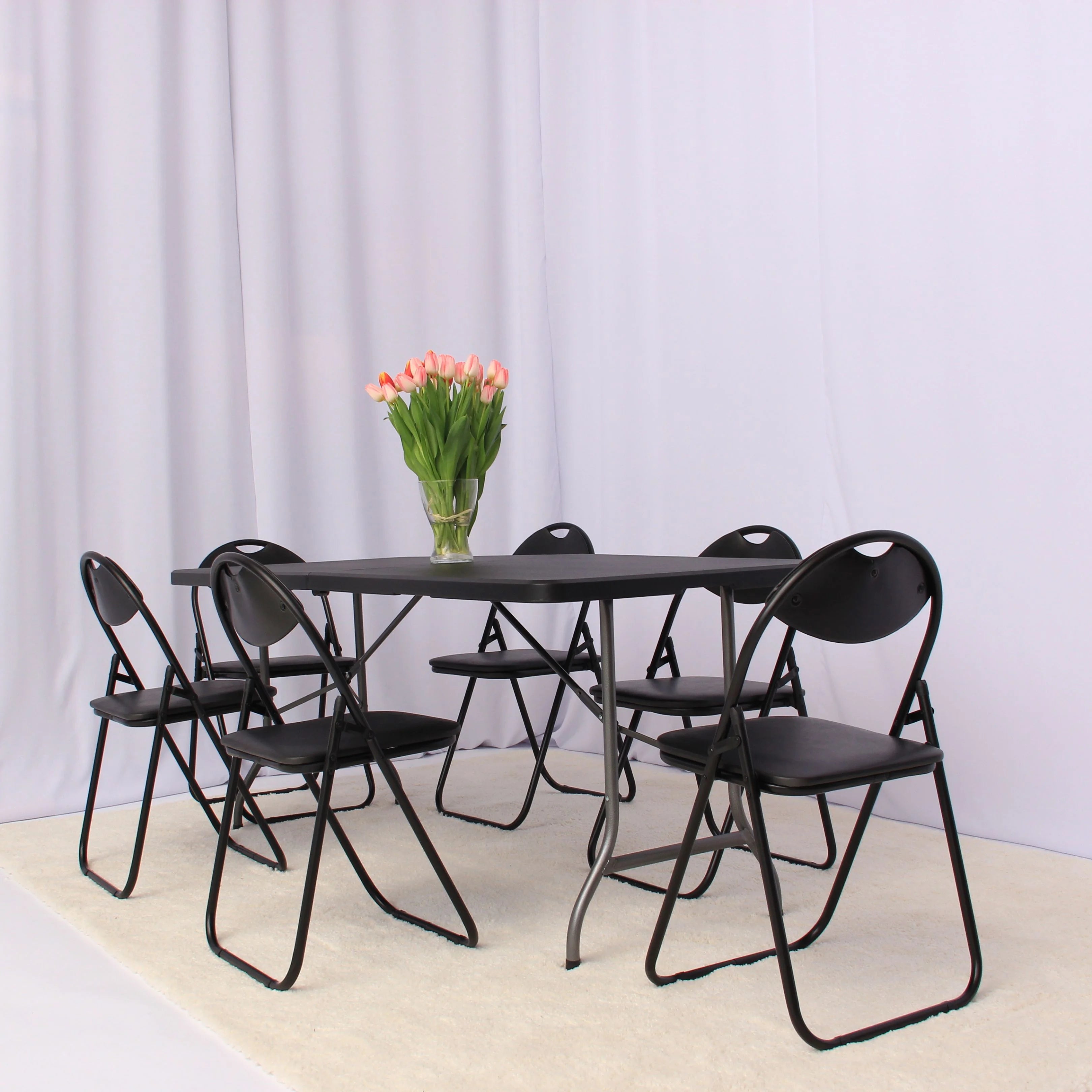 black 6ft folding table and chairs set up in modern open space