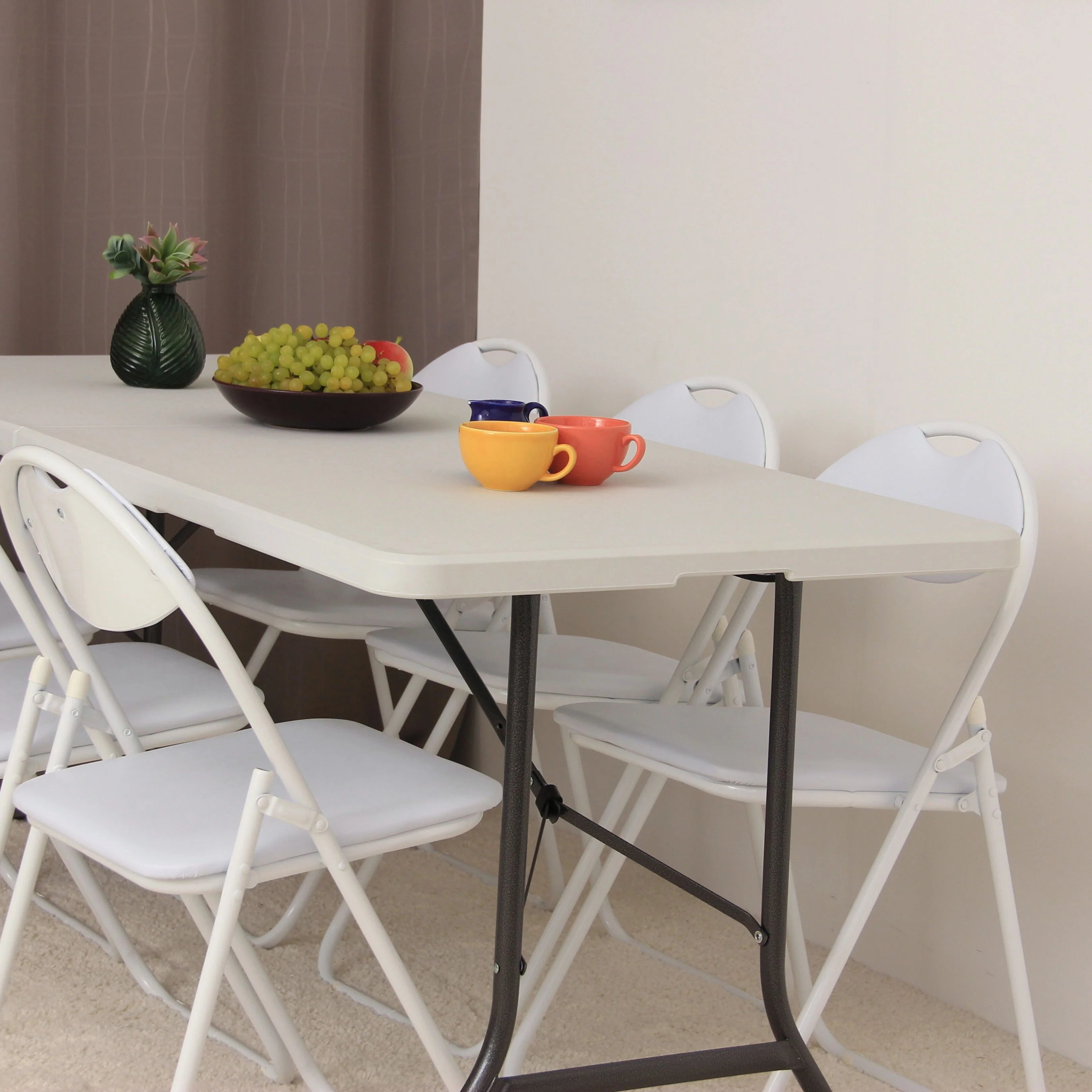 white 6ft folding table and chairs with food in bright kitchen