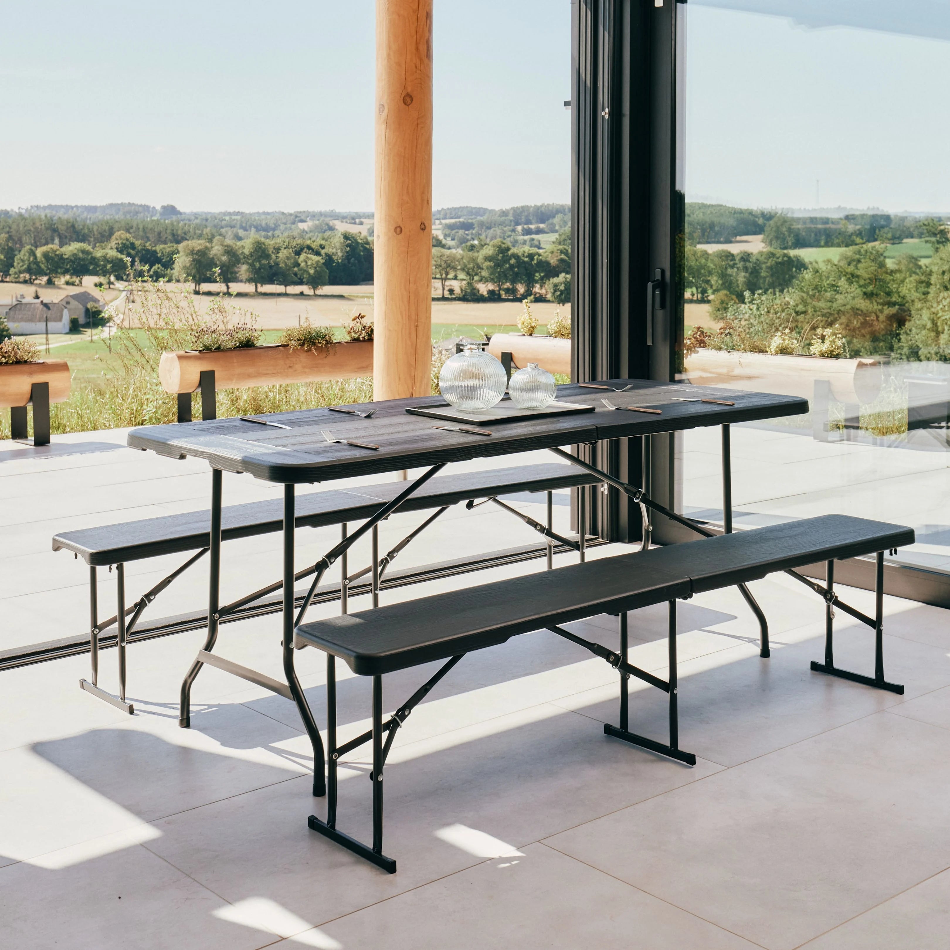 black 6ft folding table and bench on patio with scenic view