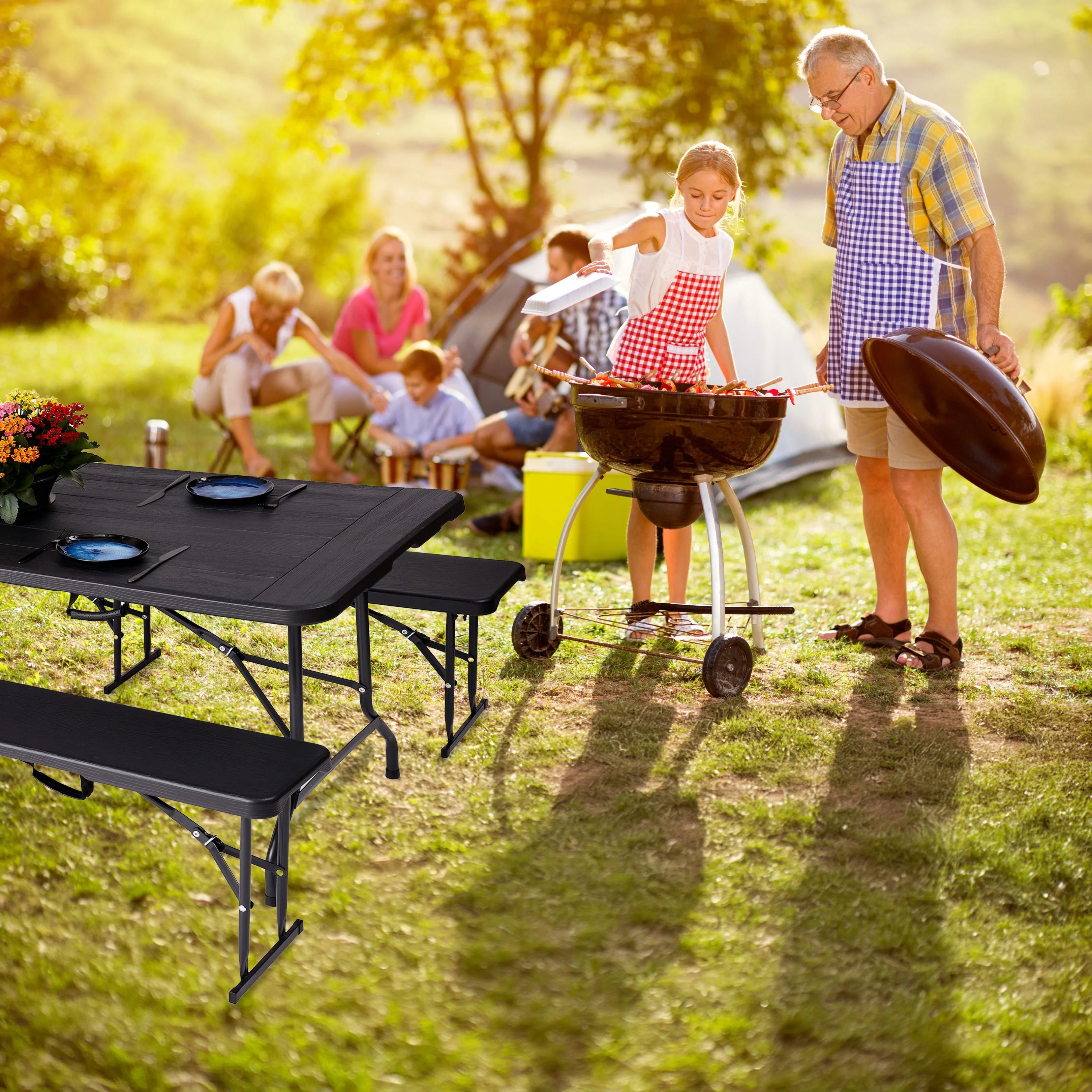 black 6ft folding table and benches in use at outdoor barbecue