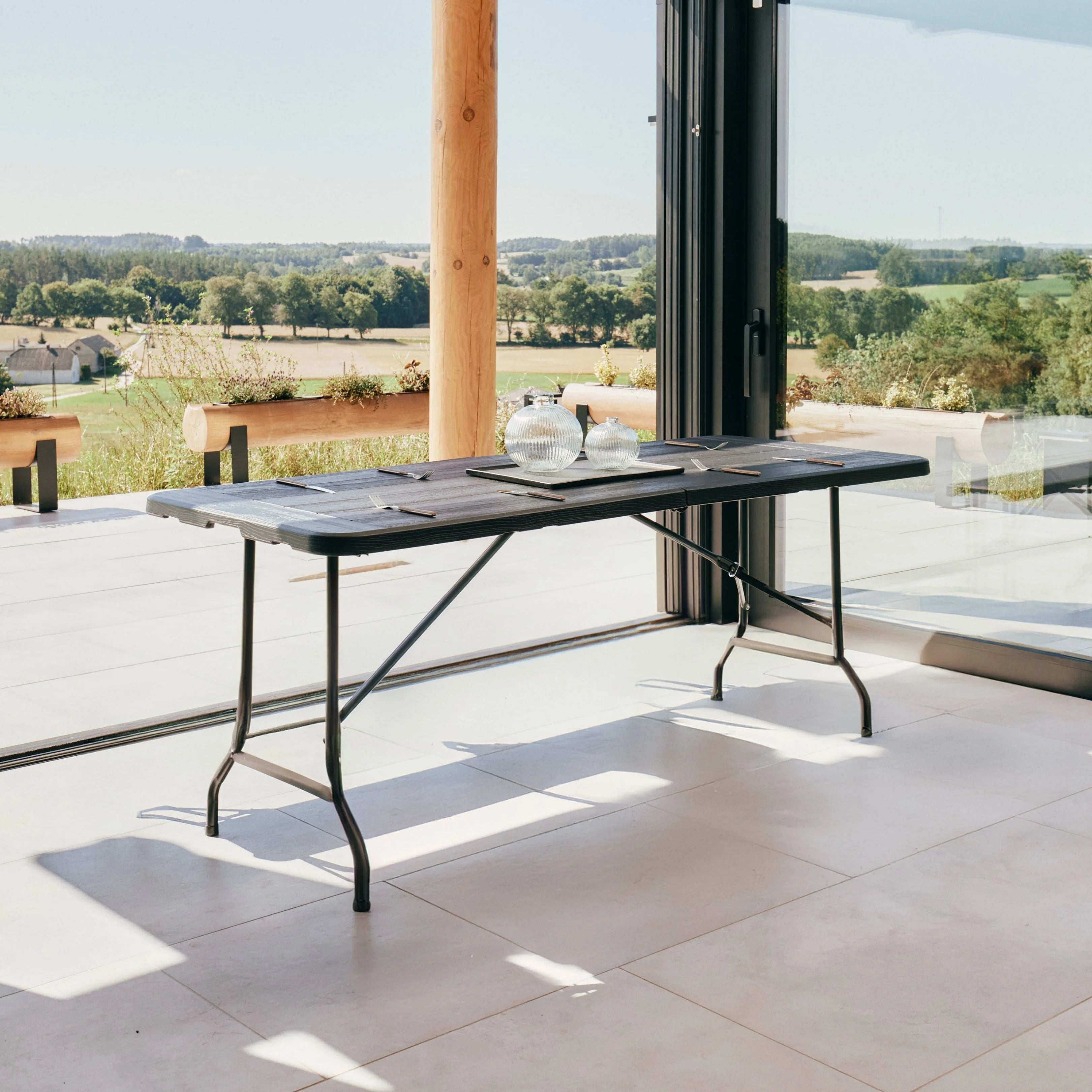 black 6ft folding table on patio with scenic view