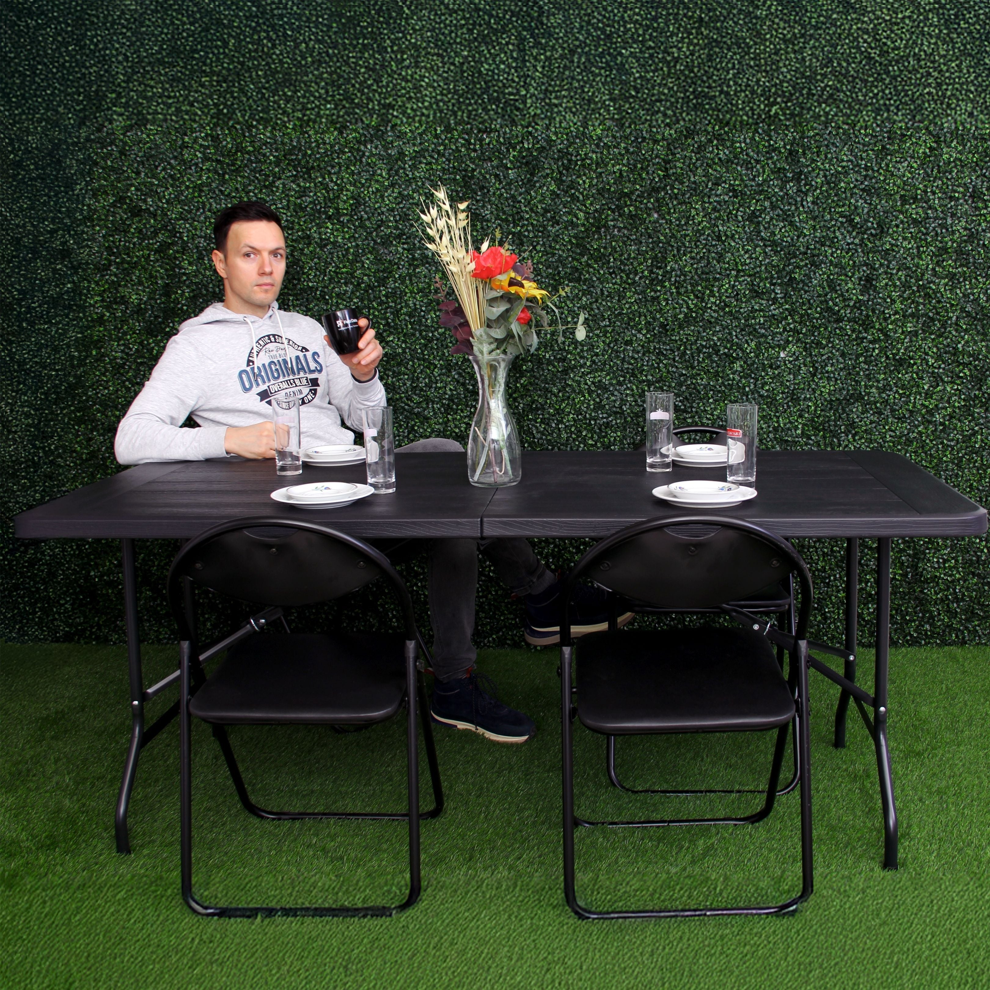 black 6ft folding table and chairs set up in modern space