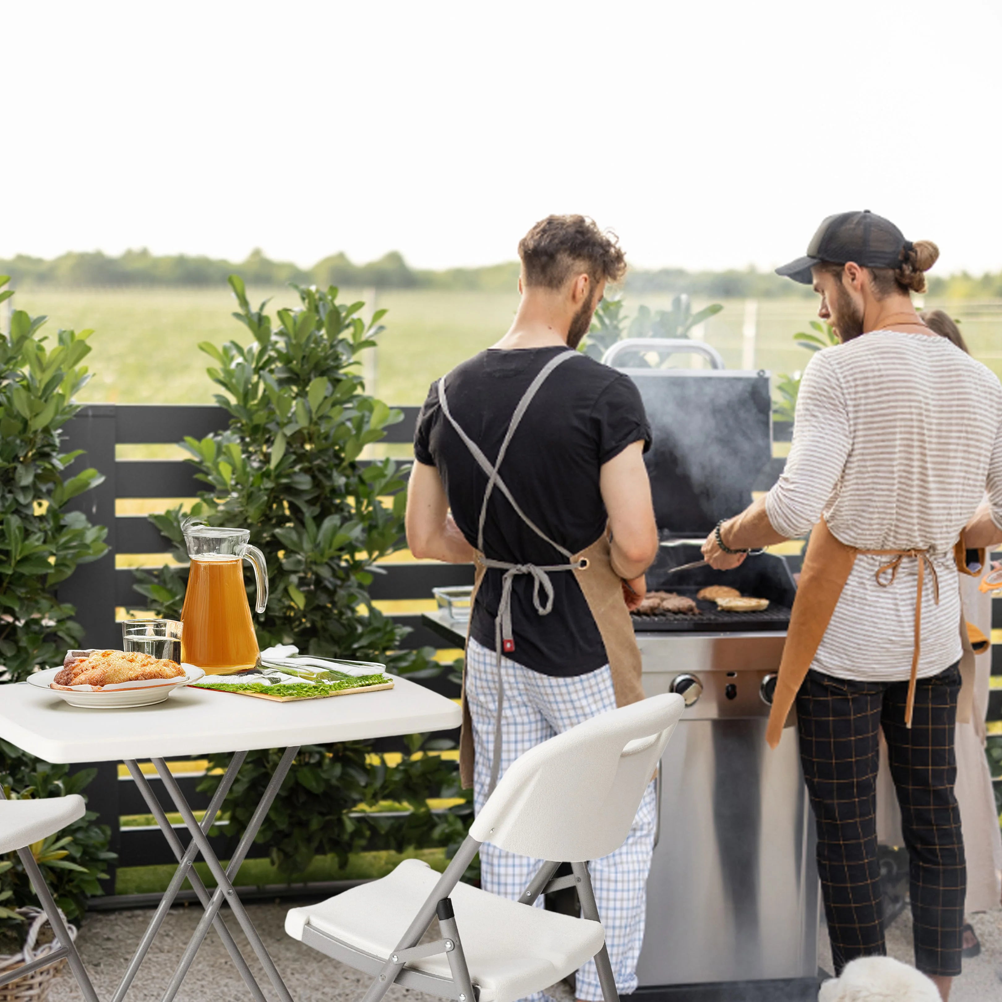 white folding table in use at outdoor barbecue