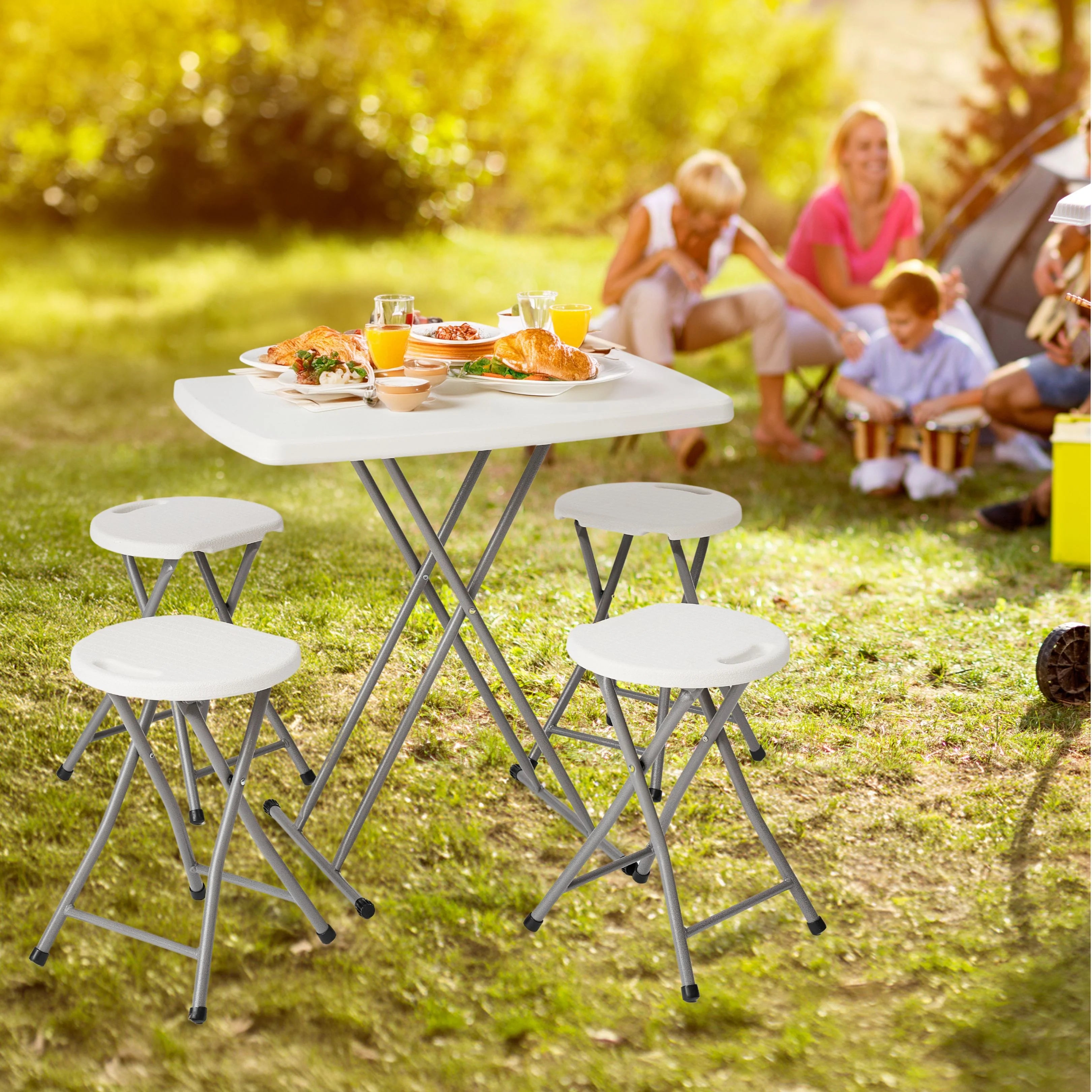 white folding table in use at outdoor barbecue