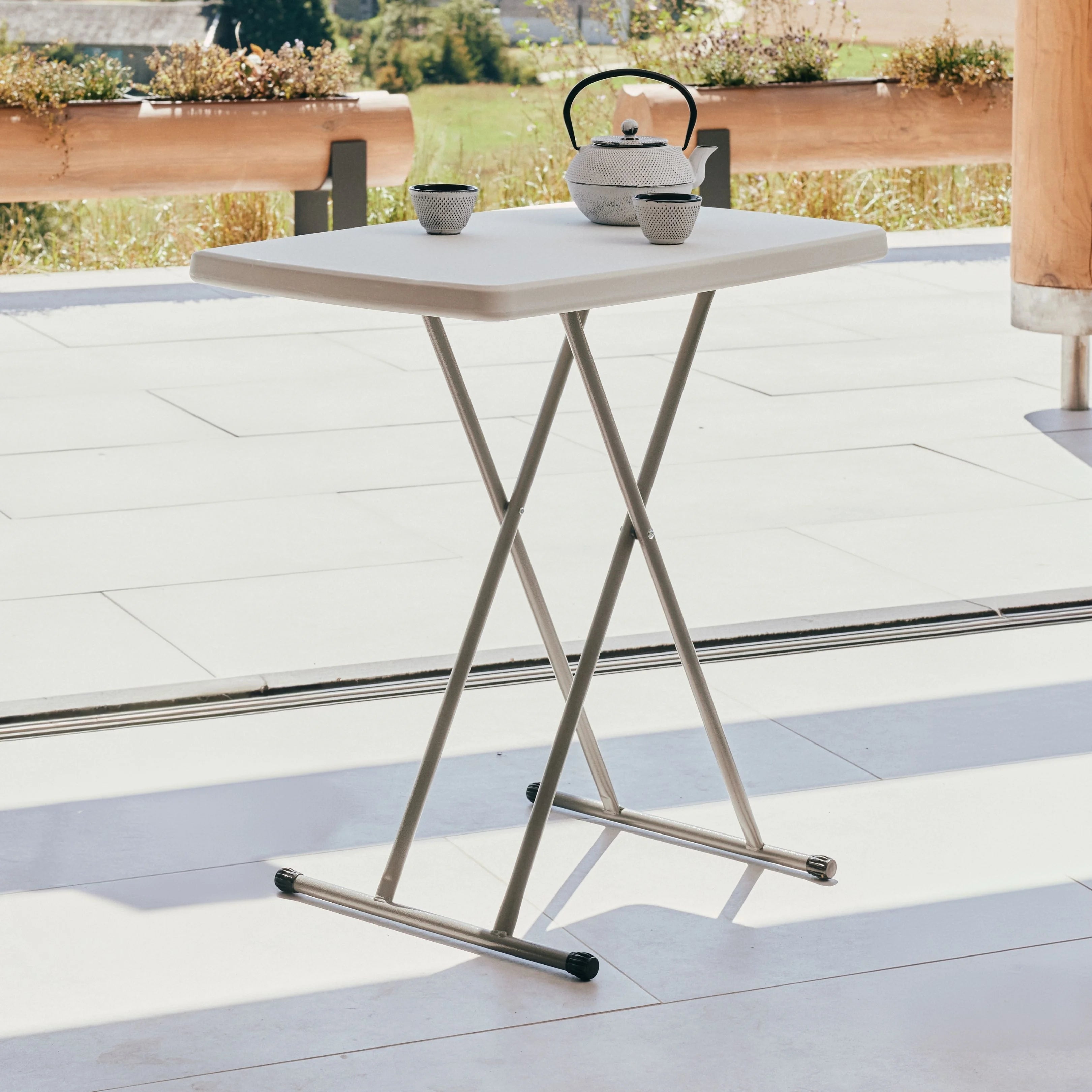 white rectangular folding table on patio with teapot