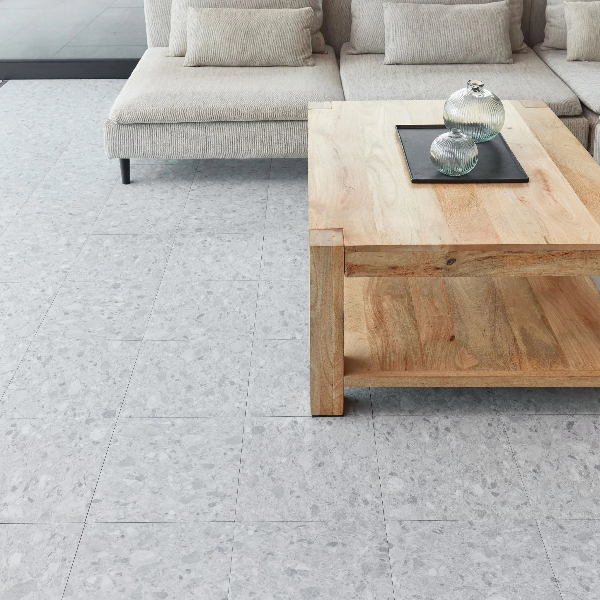 modern living room featuring grey sofa and light wood furniture on arctic grey terrazzo flooring