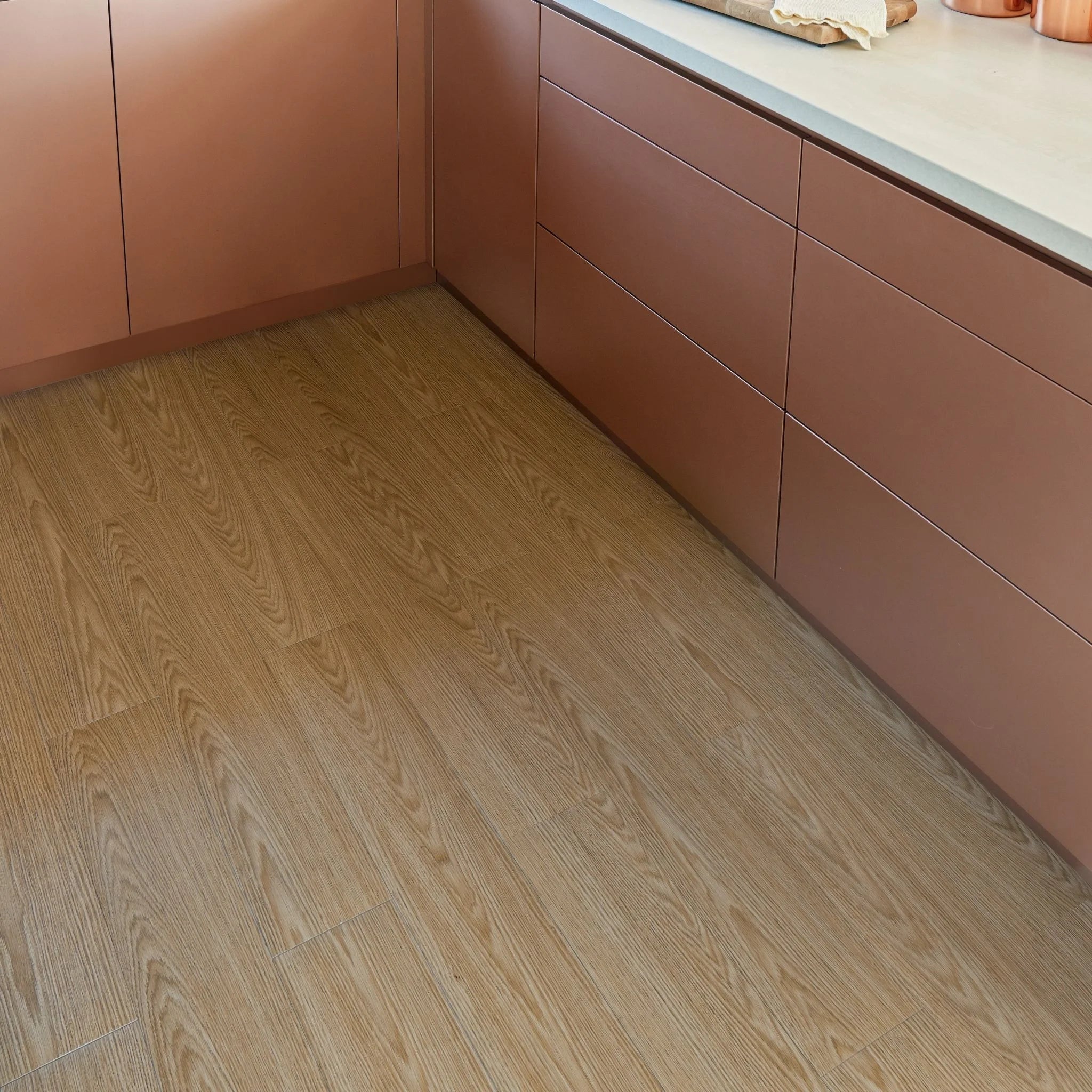 modern kitchen corner with brown cabinets and beige grey wood-effect flooring