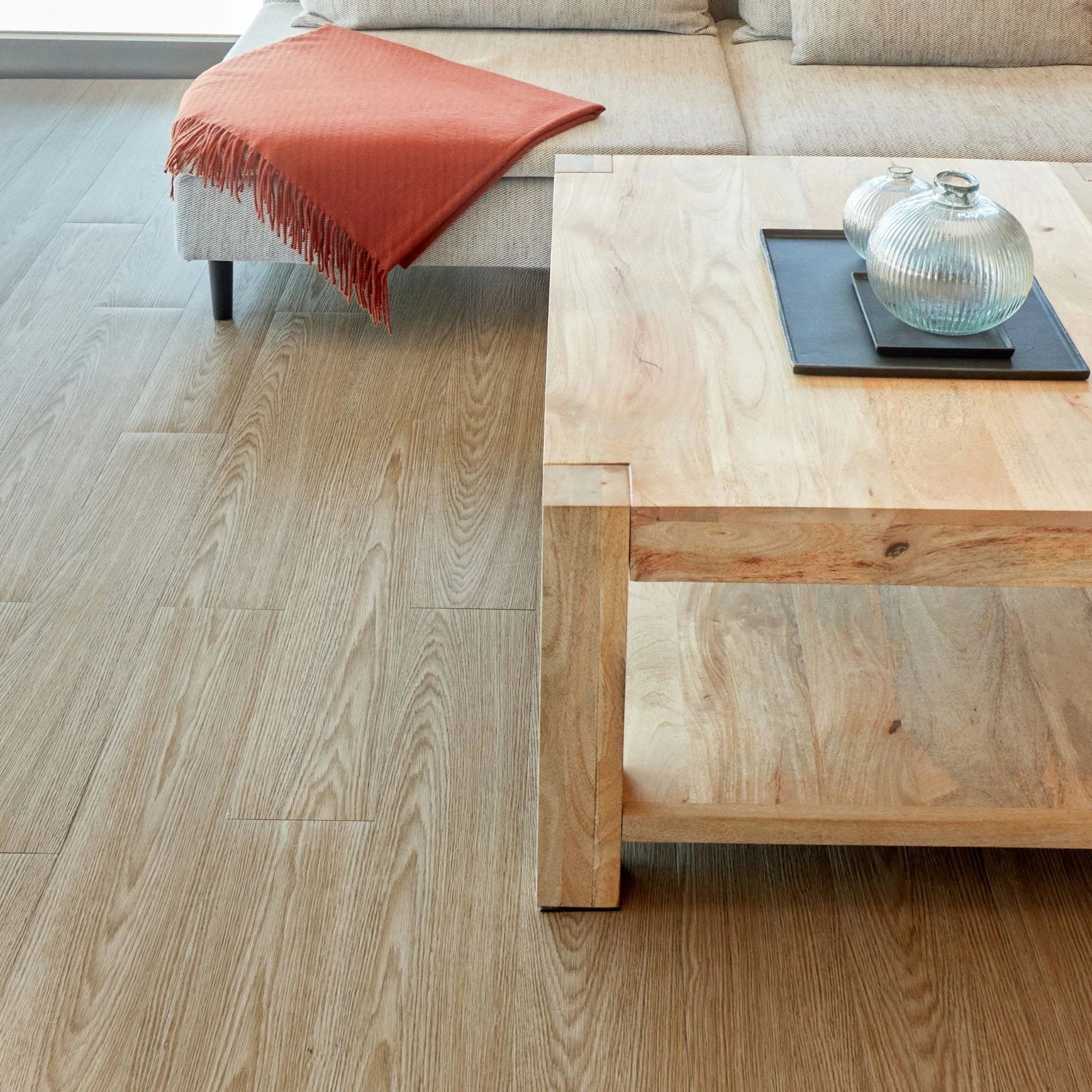 spacious living room with rustic furniture and beige grey wood-effect vinyl flooring