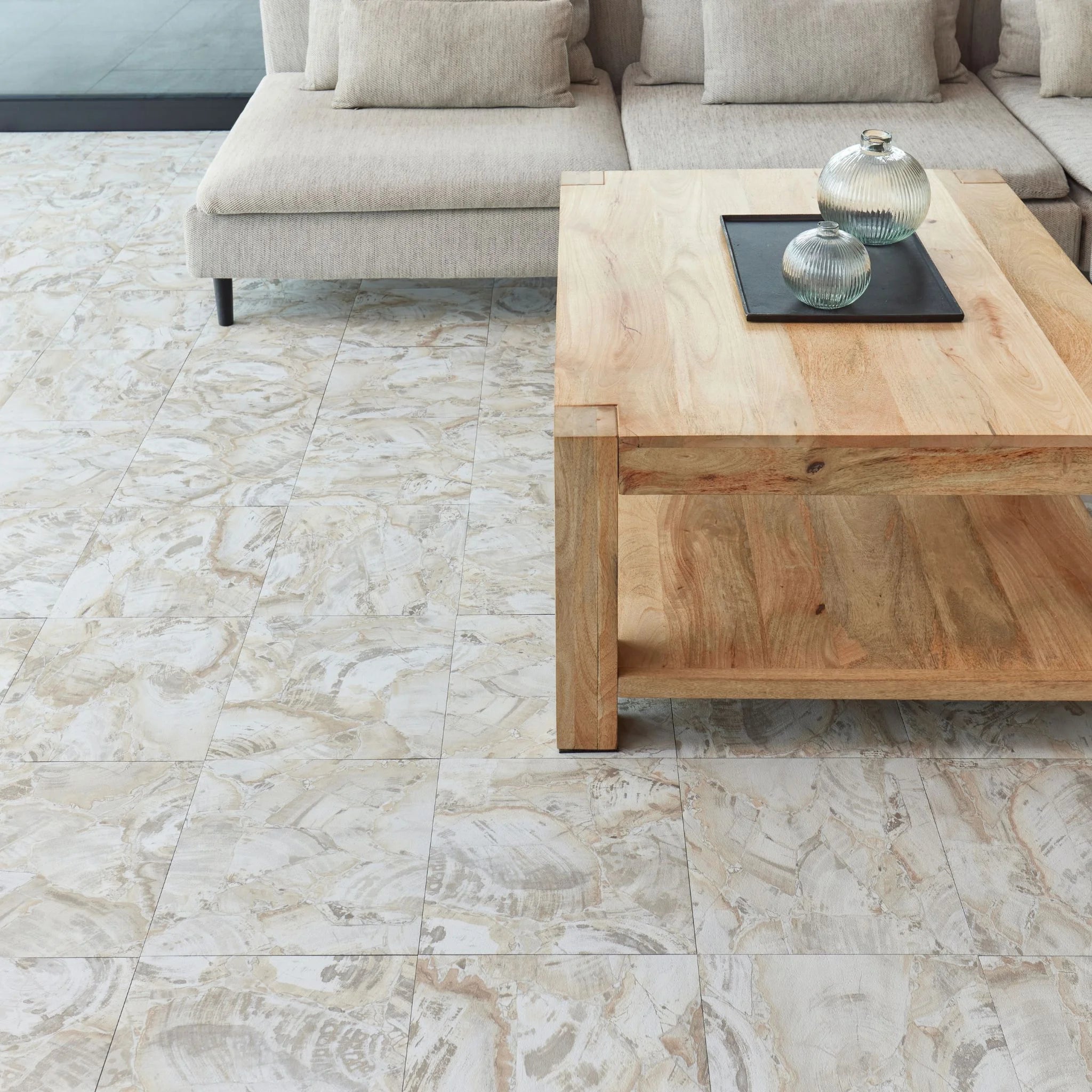 modern living room featuring grey sofa and light wood furniture on marble beige flooring